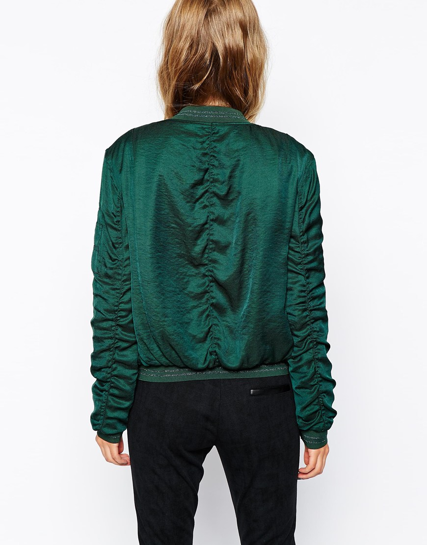 green bomber jacket with orange inside