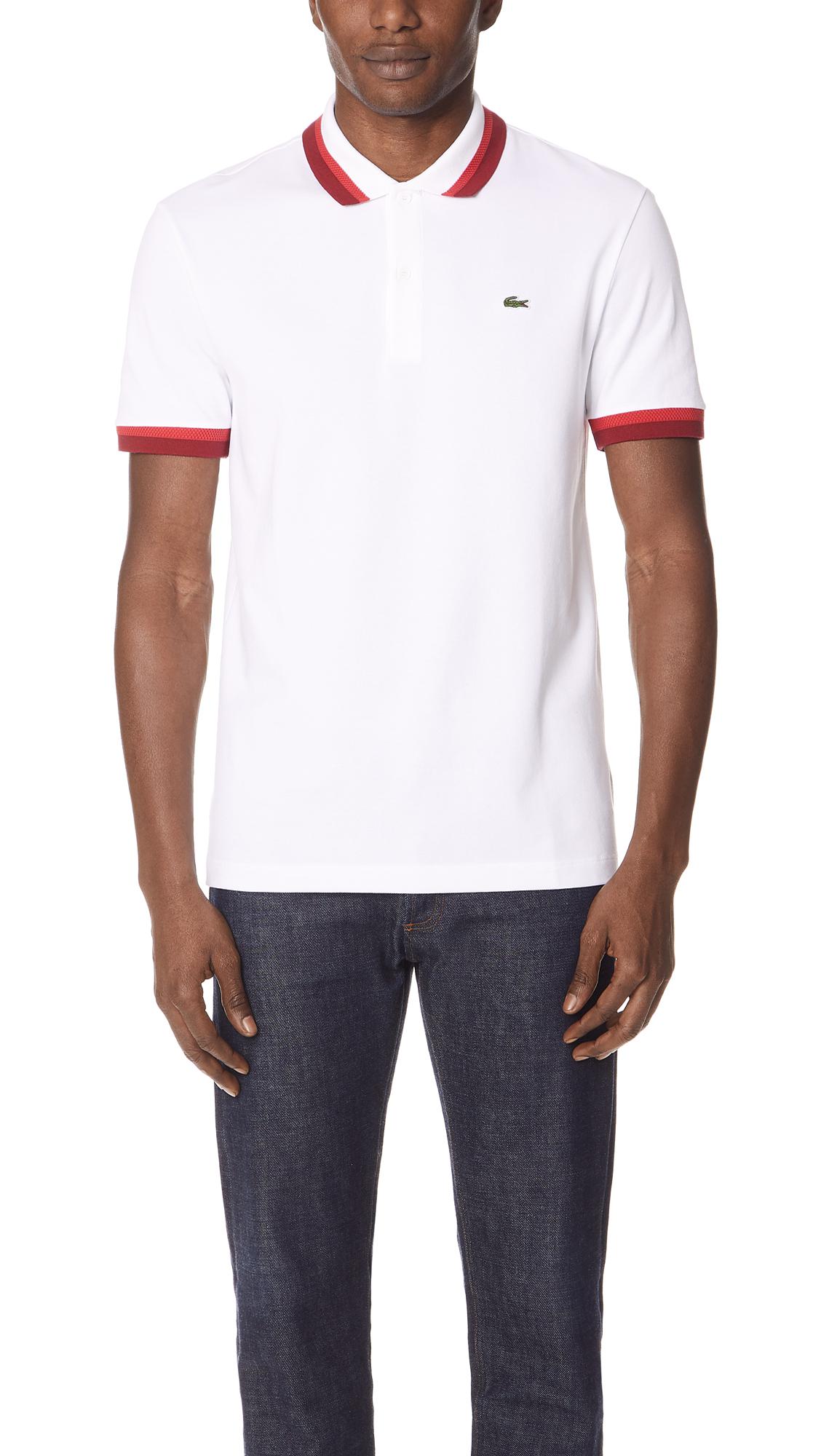 white and red lacoste shirt