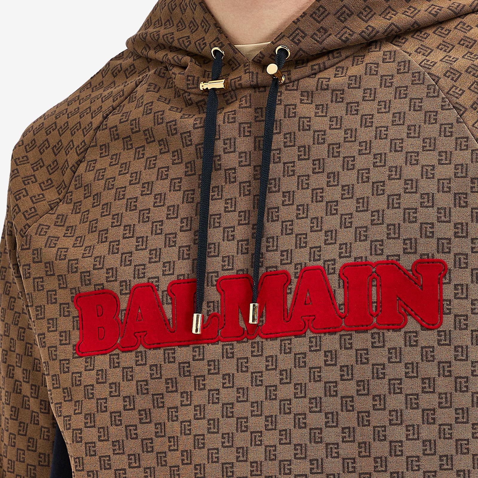 Brown hoodie with monogram logo pattern