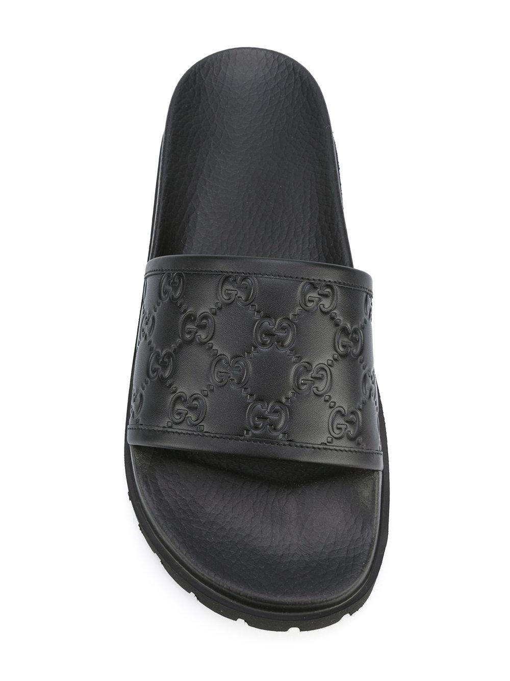 Gucci Leather Logo Embossed Slides in Black - Lyst