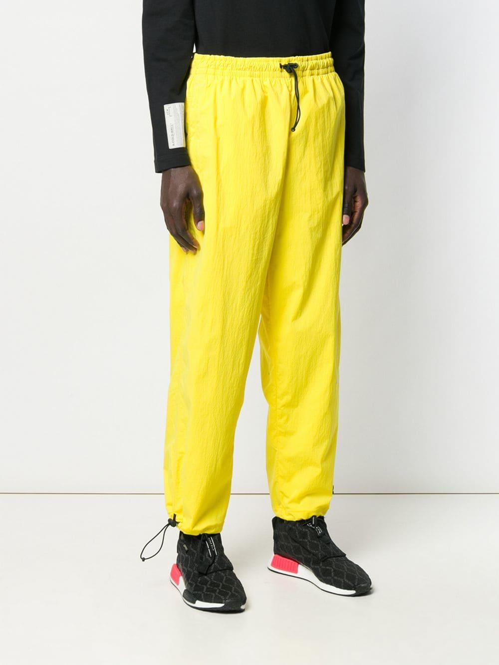 yellow nike track pants