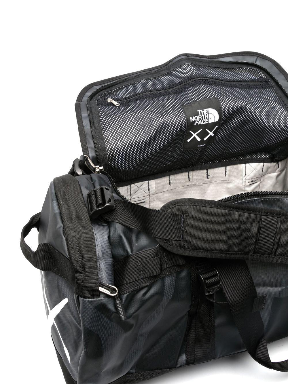 The North Face X Kaws Basecamp Duffle Bag in Black for Men | Lyst