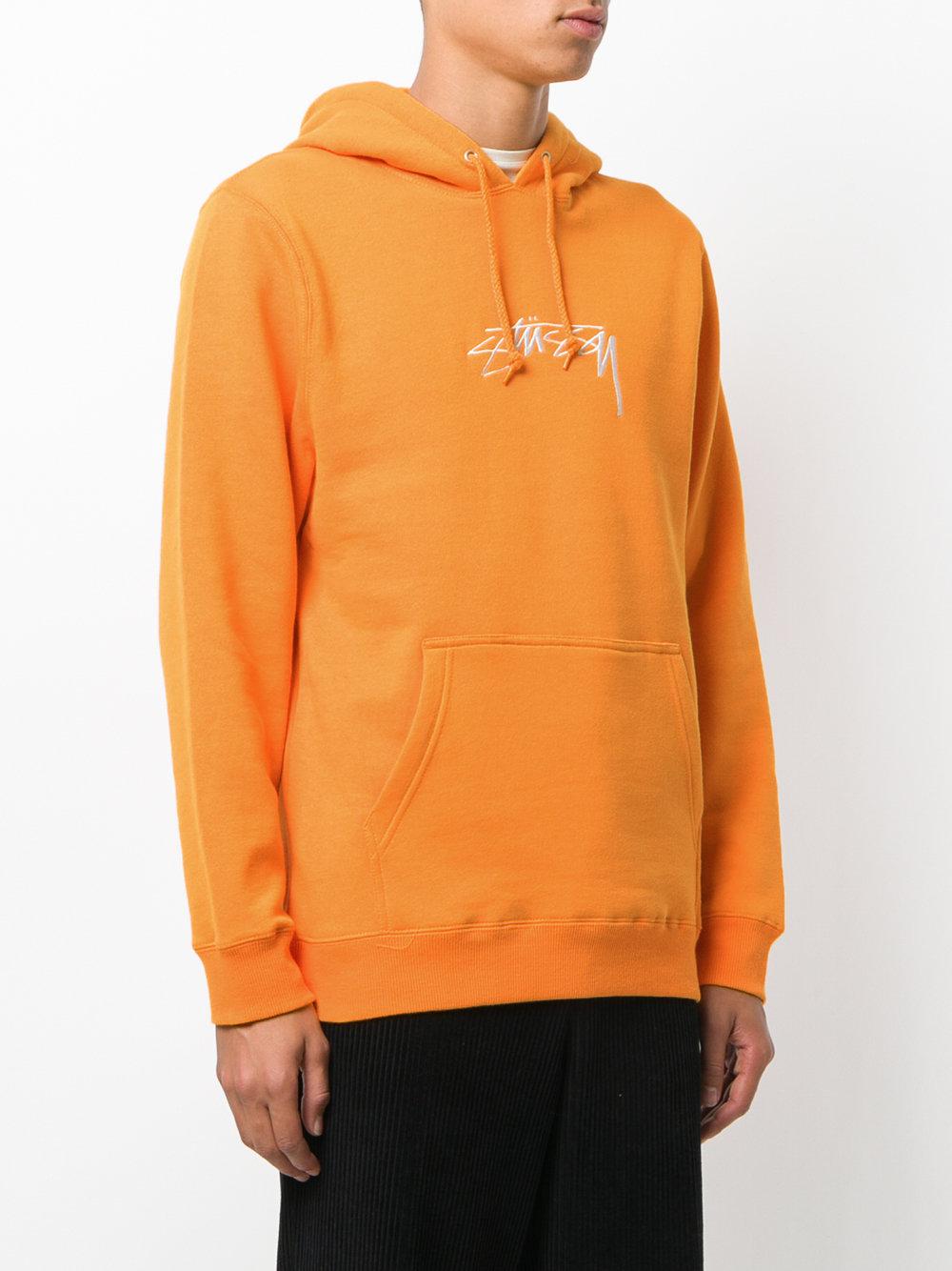 felpa arancione stussy