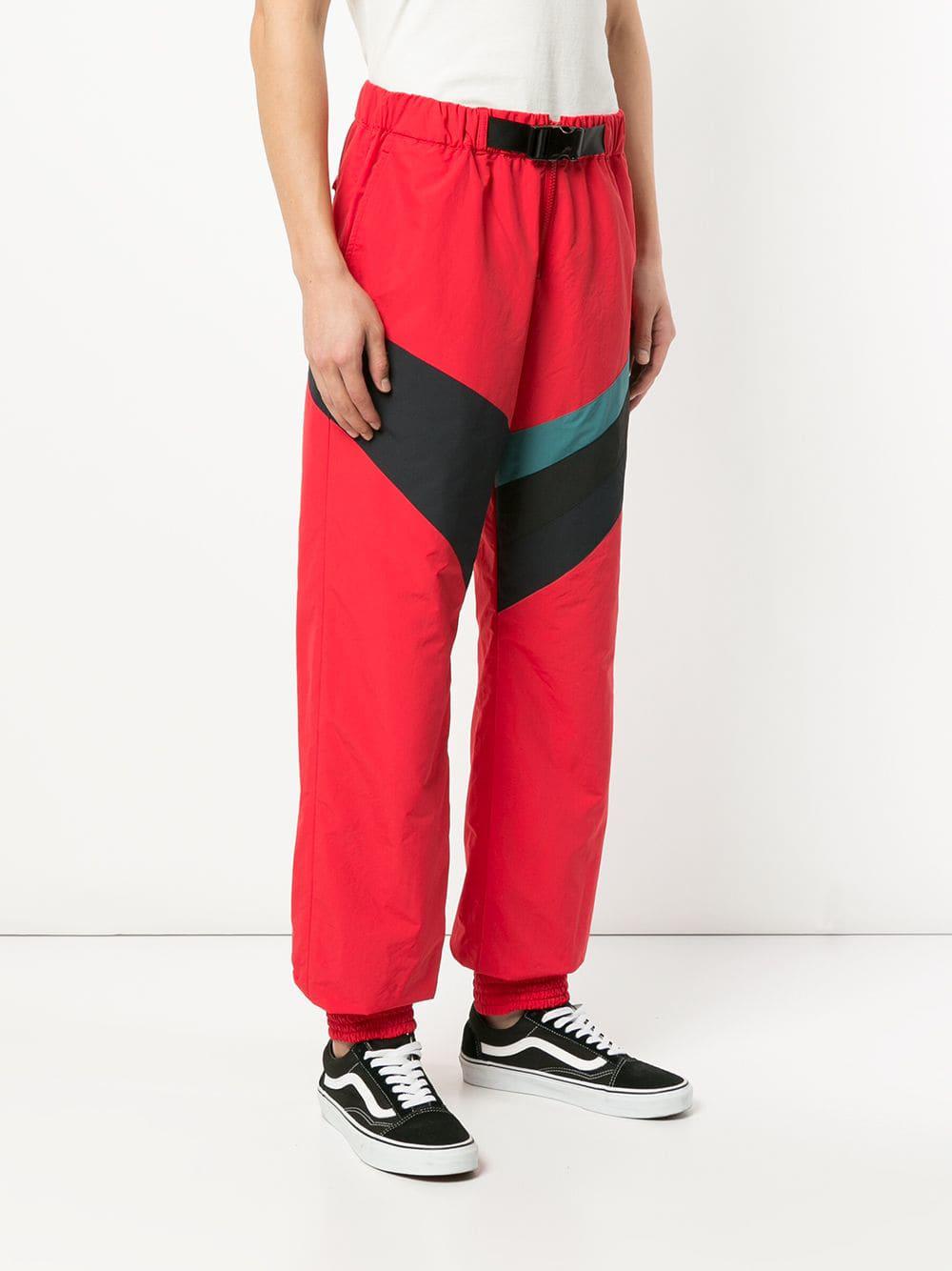 red track pants with white stripe