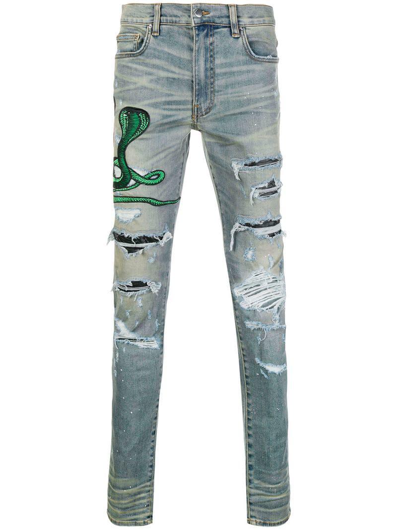 Jeans con strappi decorativi con applicazione serpente da Uomo di Amiri in  Blu | Lyst