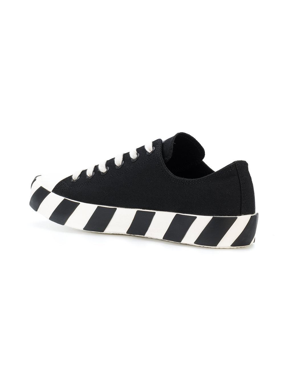 white tennis shoes with black stripes