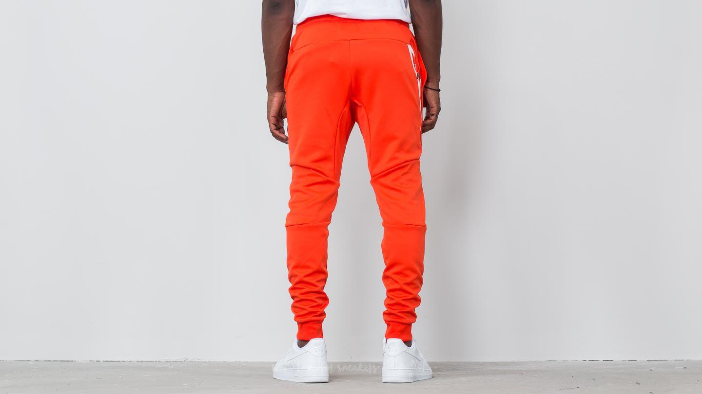 orange nike tech pants