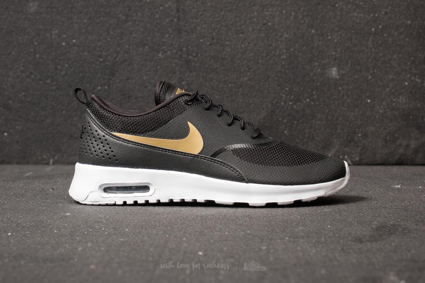 nike thea womens black and gold