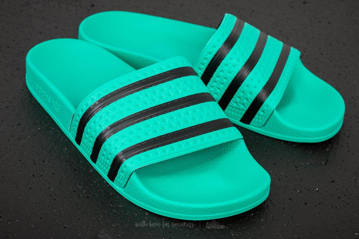 green and black adidas slides