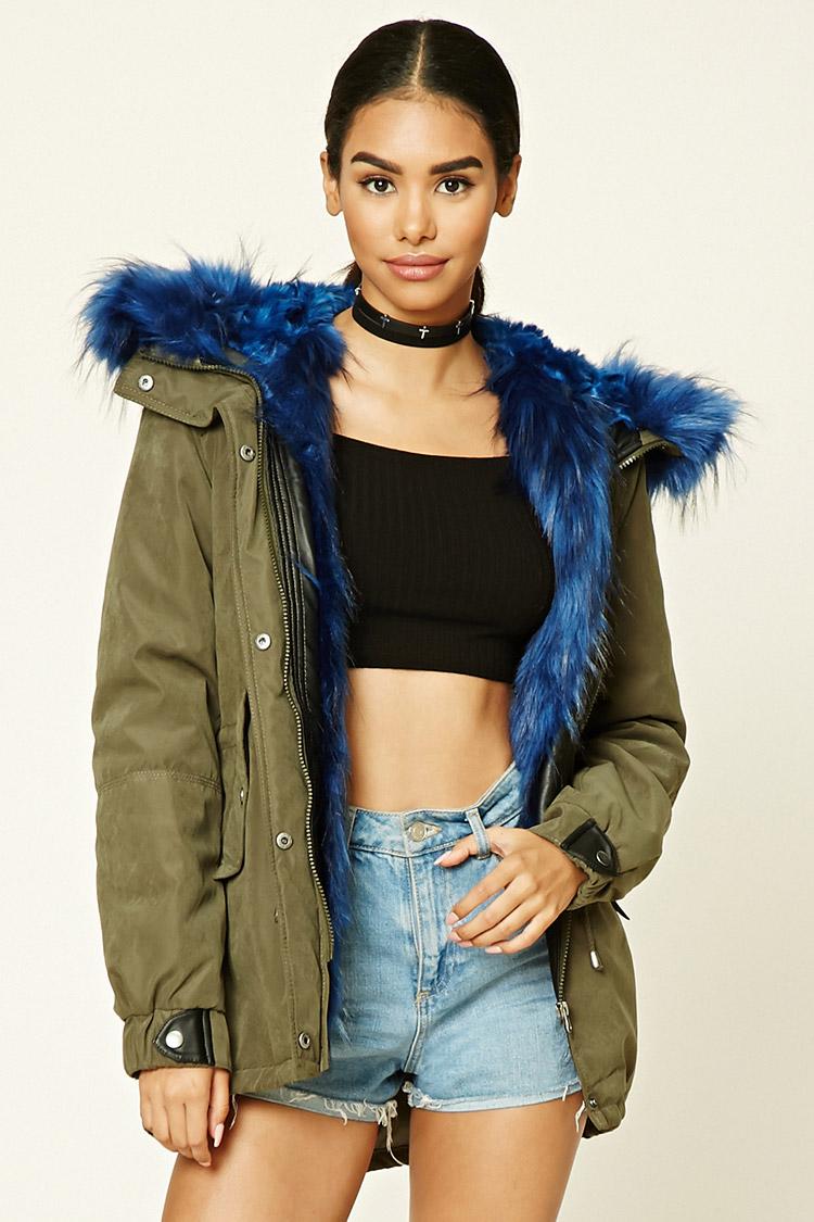 green parka with blue fur hood