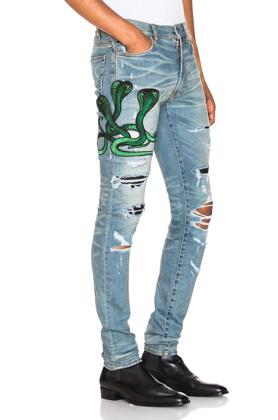 amiri jeans with green snake