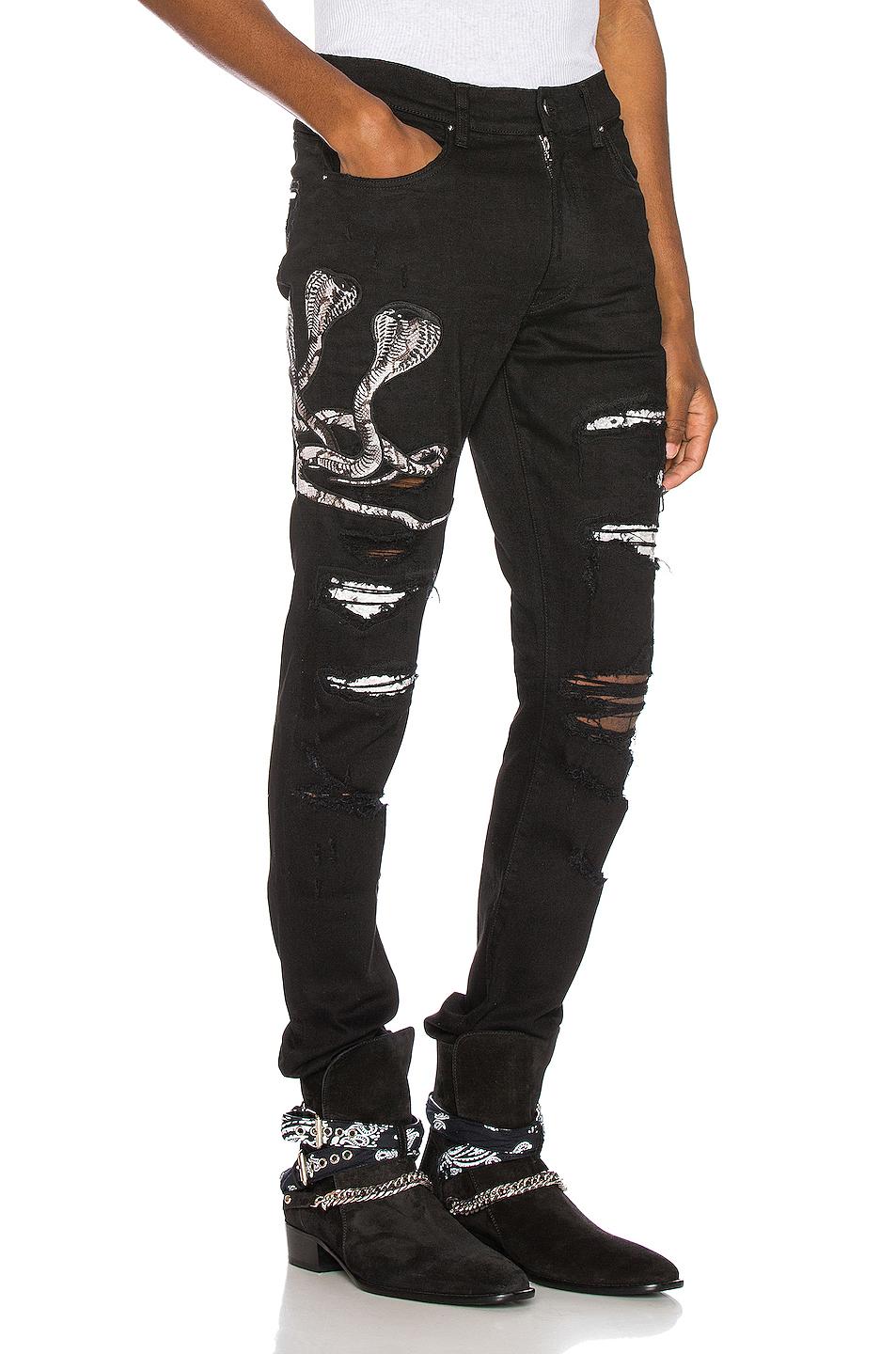 black amiri jeans with snake
