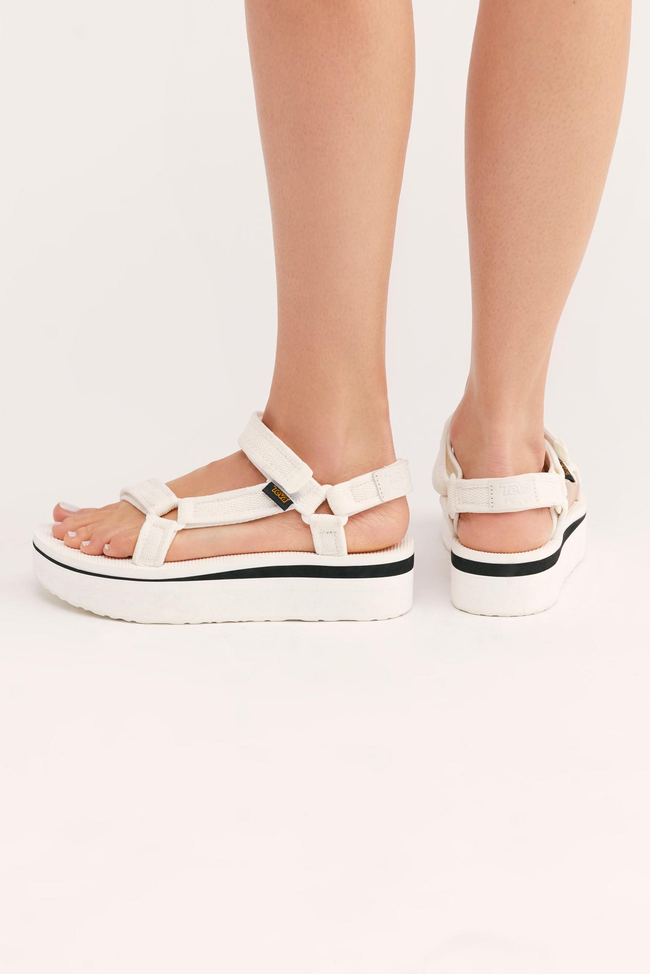 white teva flatforms