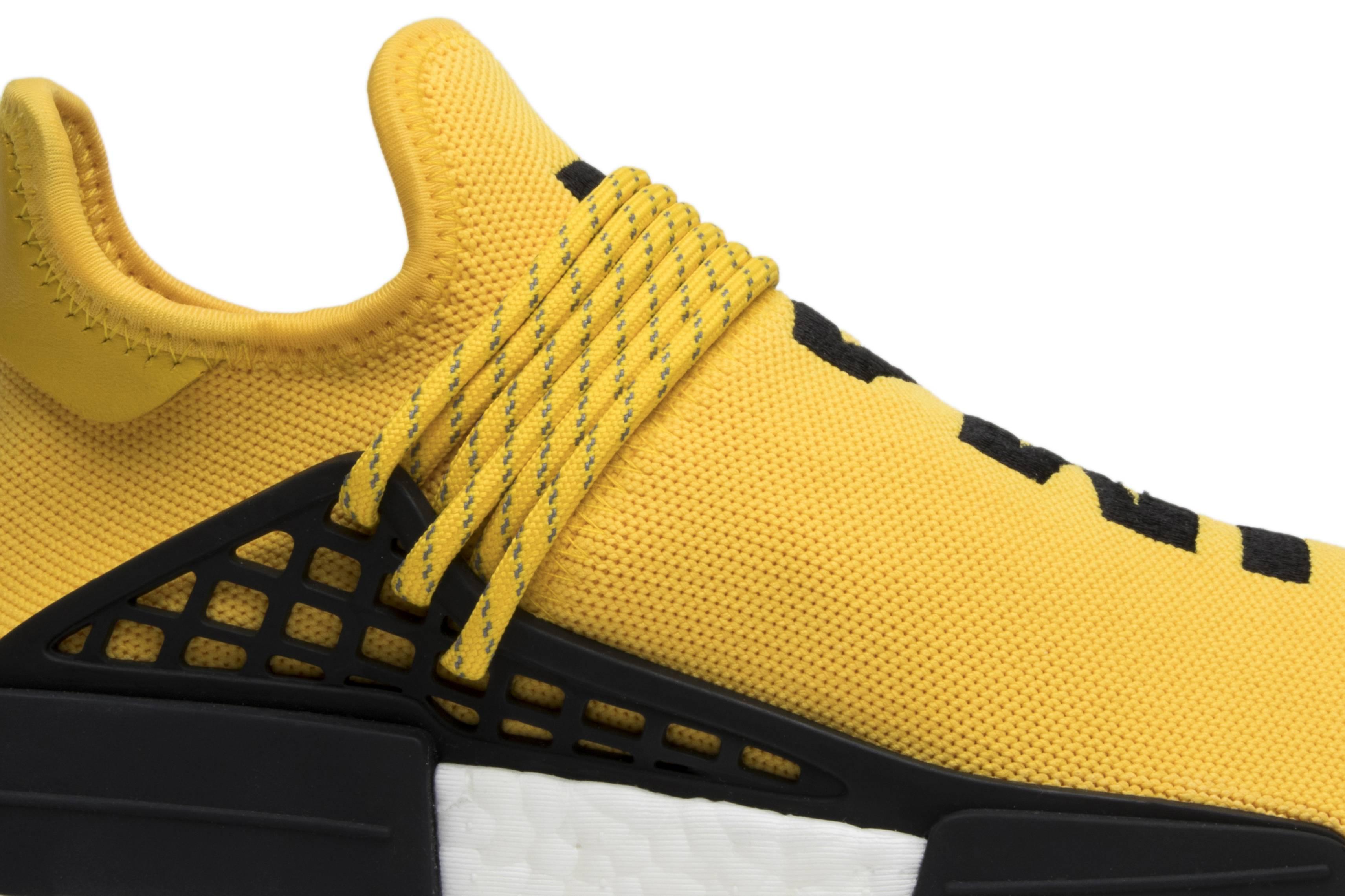 black and yellow human race shoes