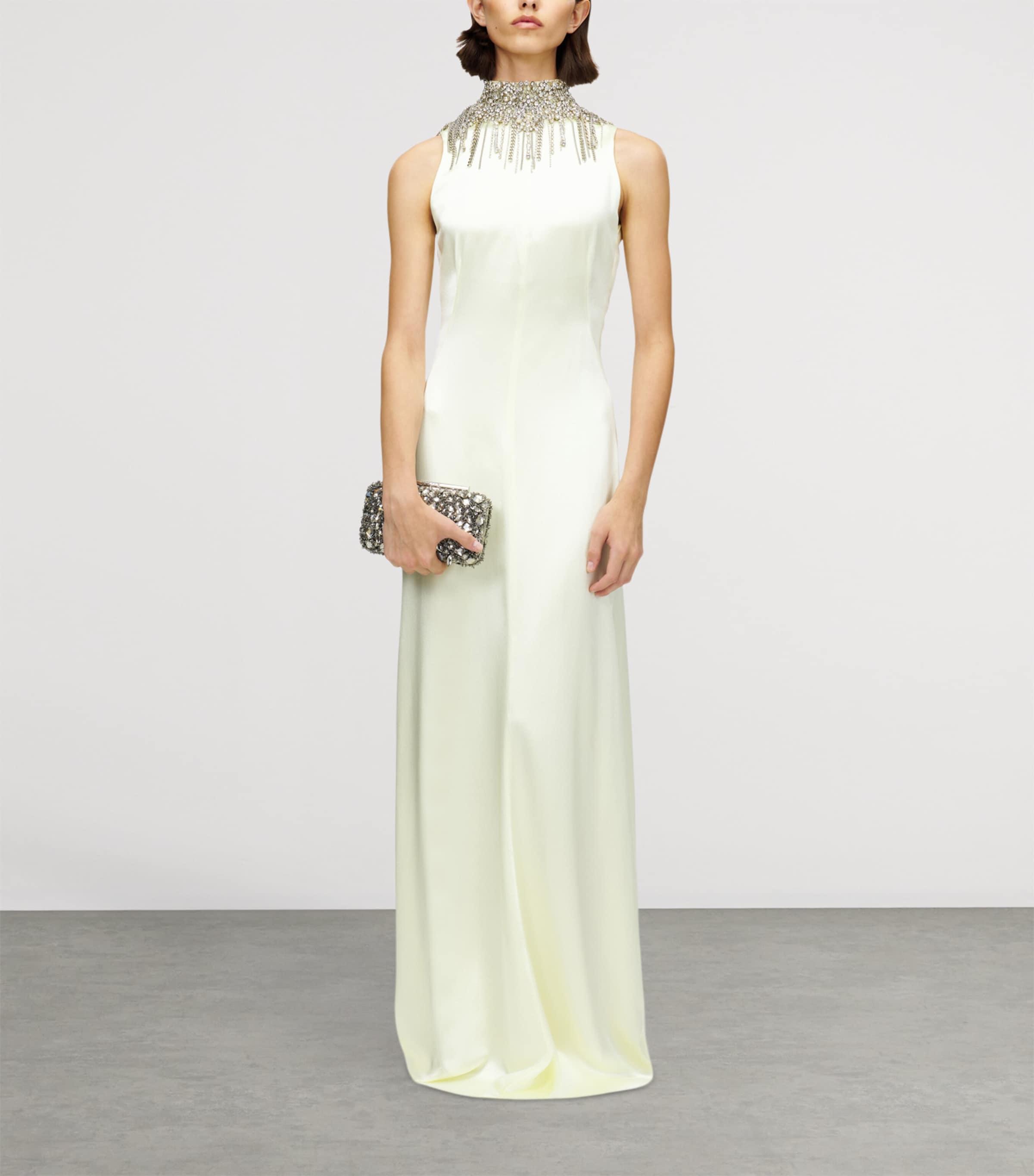 alexander mcqueen white long dress Alexander McQueen Paris Ready to Wear Autumn Winter Final Show White  flolength pleated dress and white structured coat gold Stock Photo