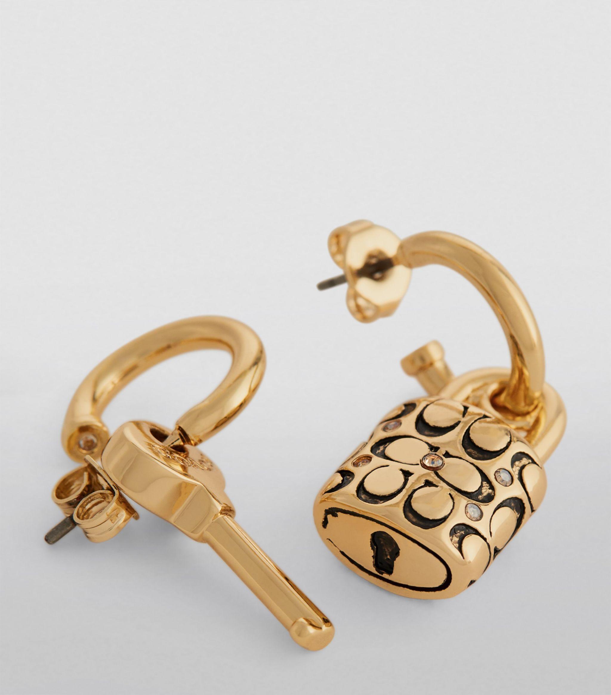 COACH Signature Lock Key Charm Huggies Earrings in White | Lyst