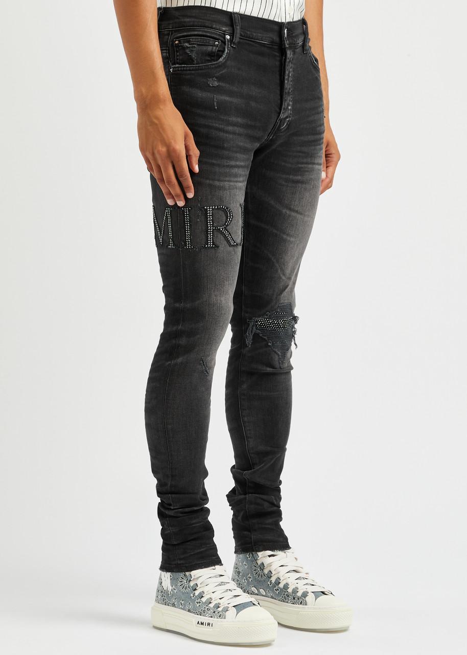Amiri Logo-embellished Distressed Skinny Jeans in Black for