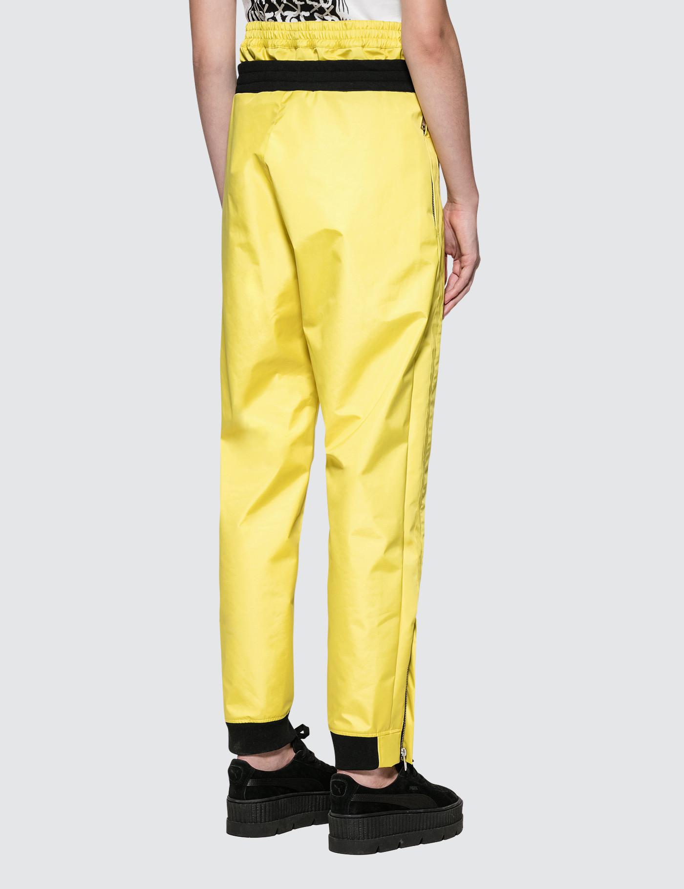 yellow track pants with white stripe