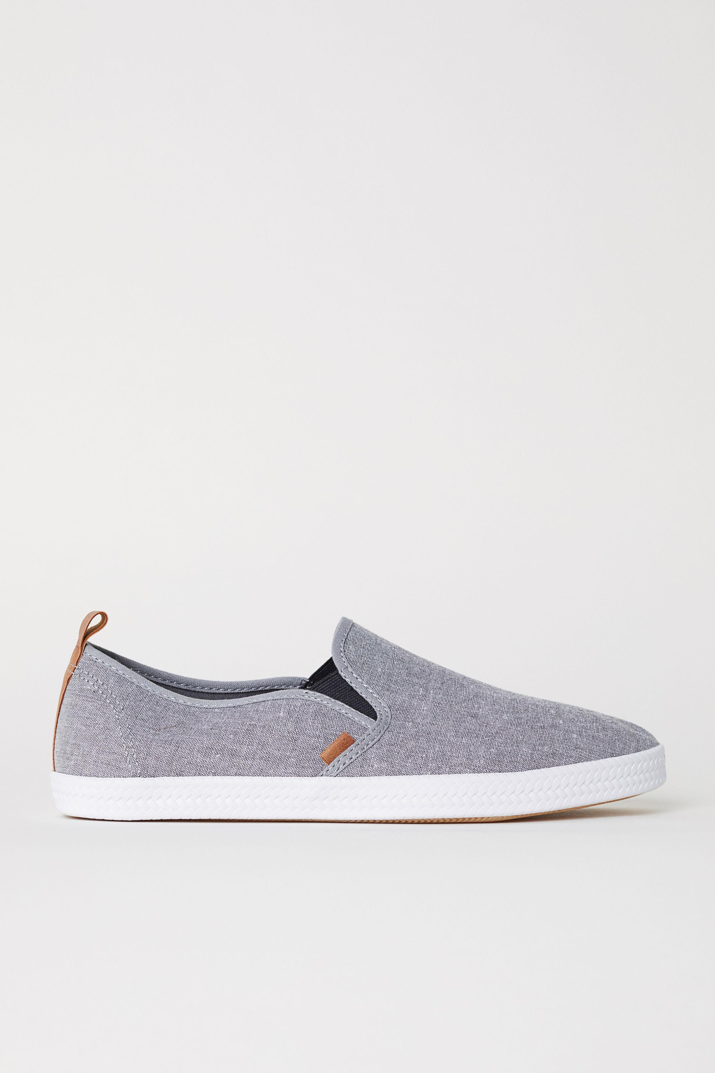 black and grey slip ons