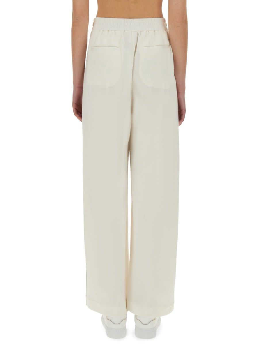パンツ BRUNELLO CUCINELLI TRACK PANTS WITH NECKLACE Brunello Cucinelli Track Pants With Necklace in Natural | Lyst