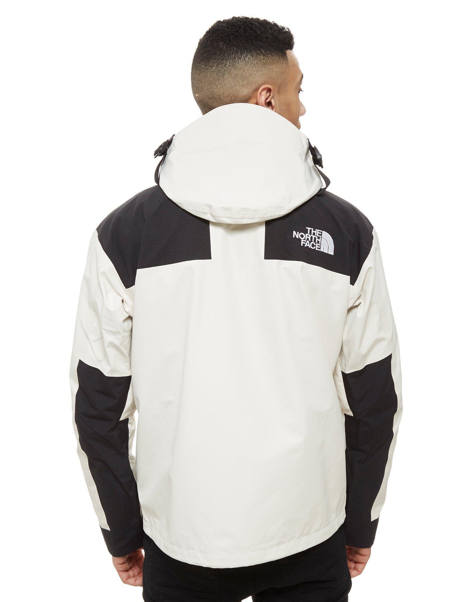 white and black north face coat