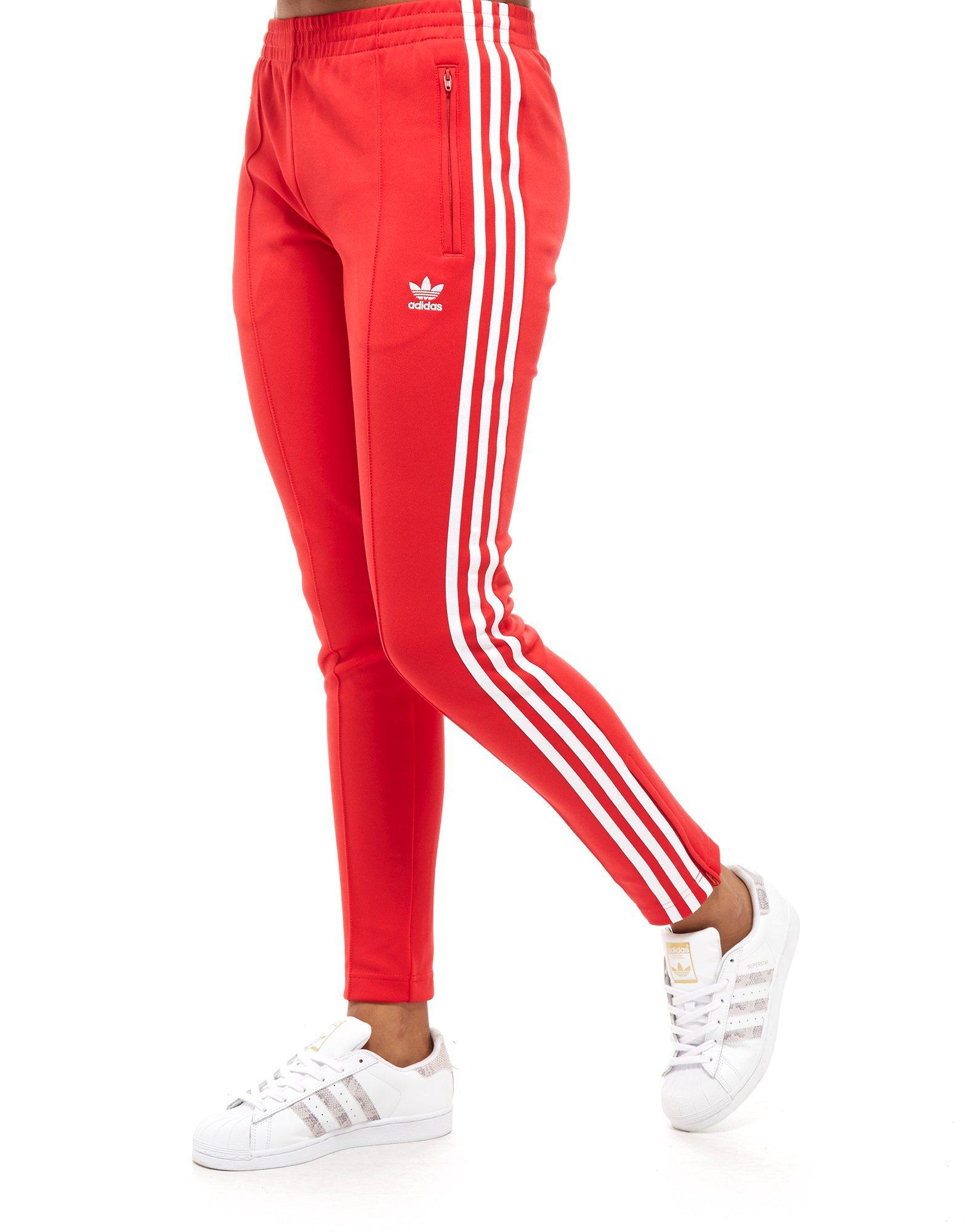 red and white adidas track pants