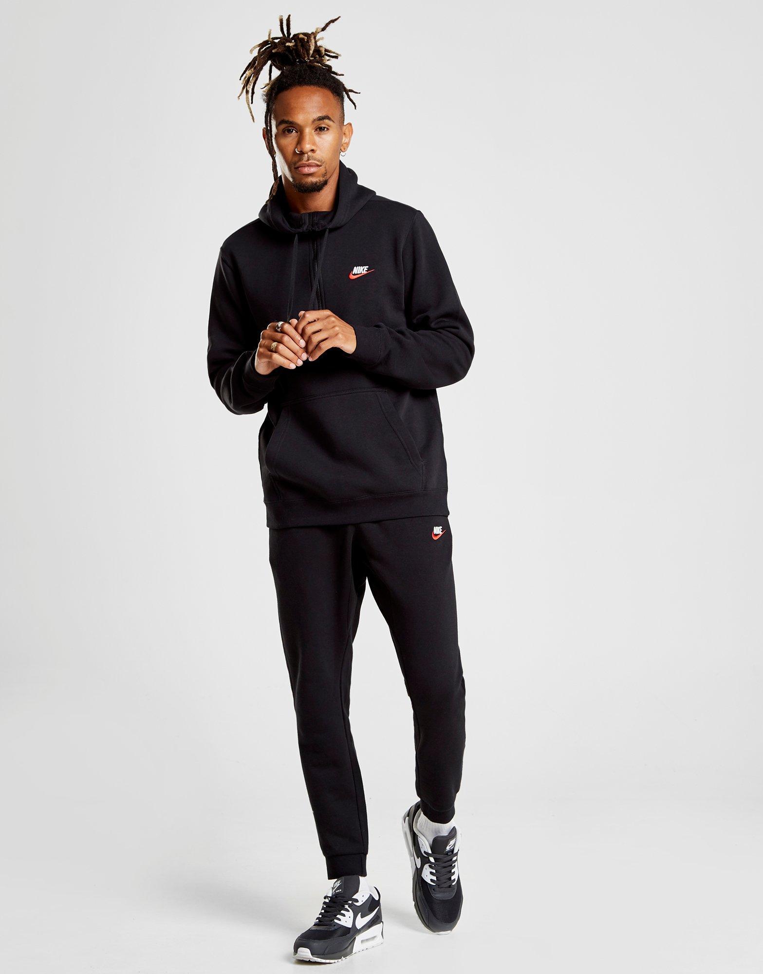 black nike tracksuit with red tick