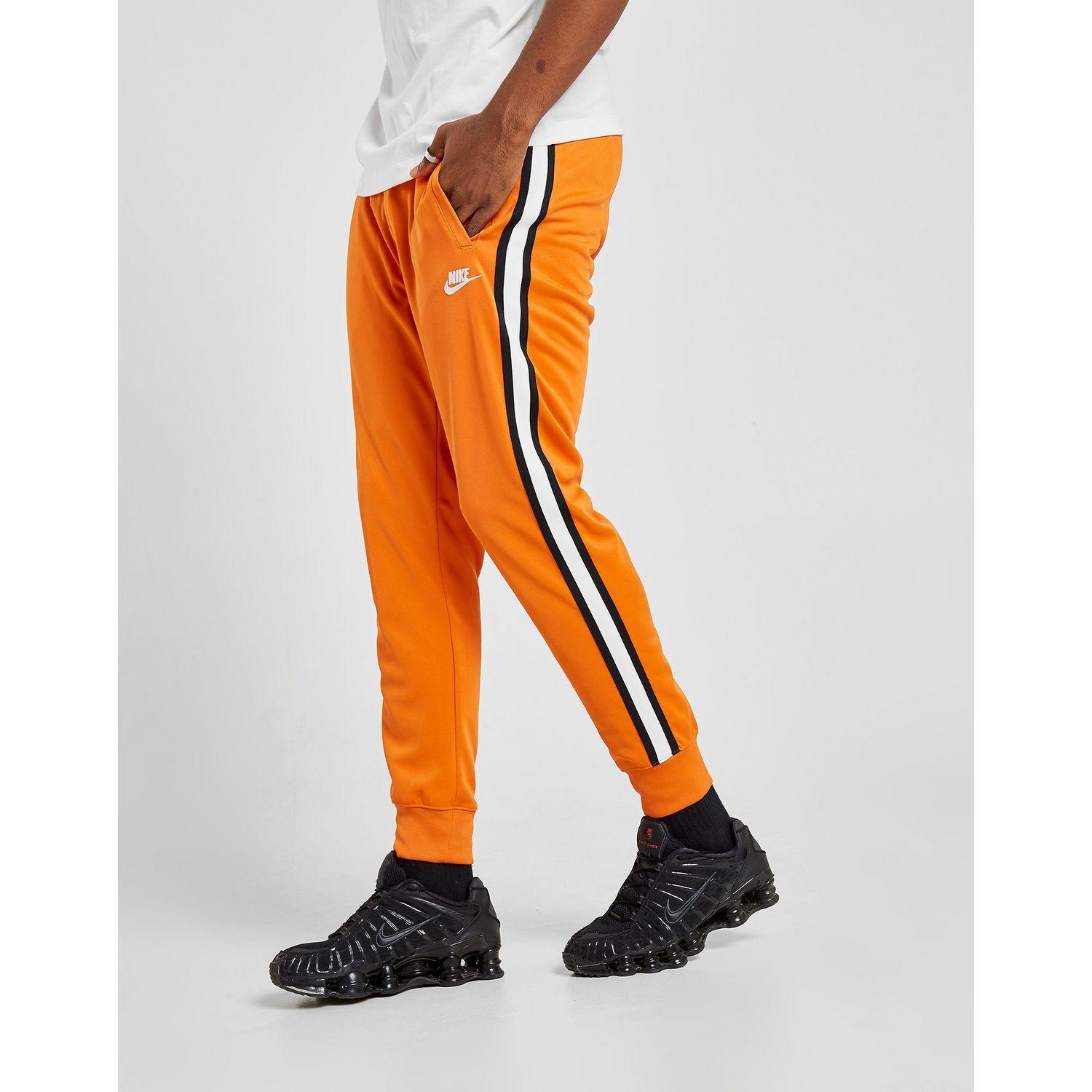 nike track pants orange