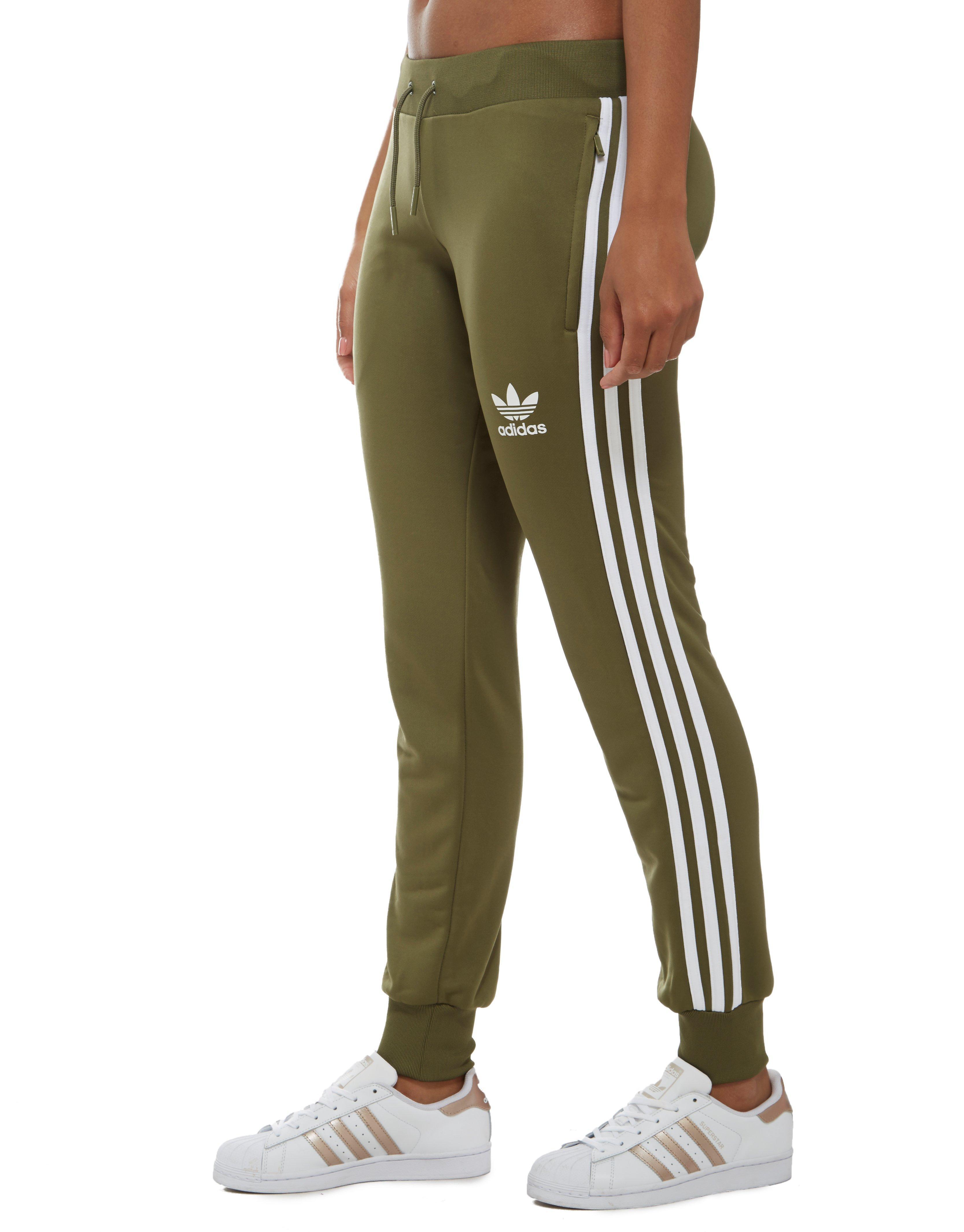 green and white adidas track pants