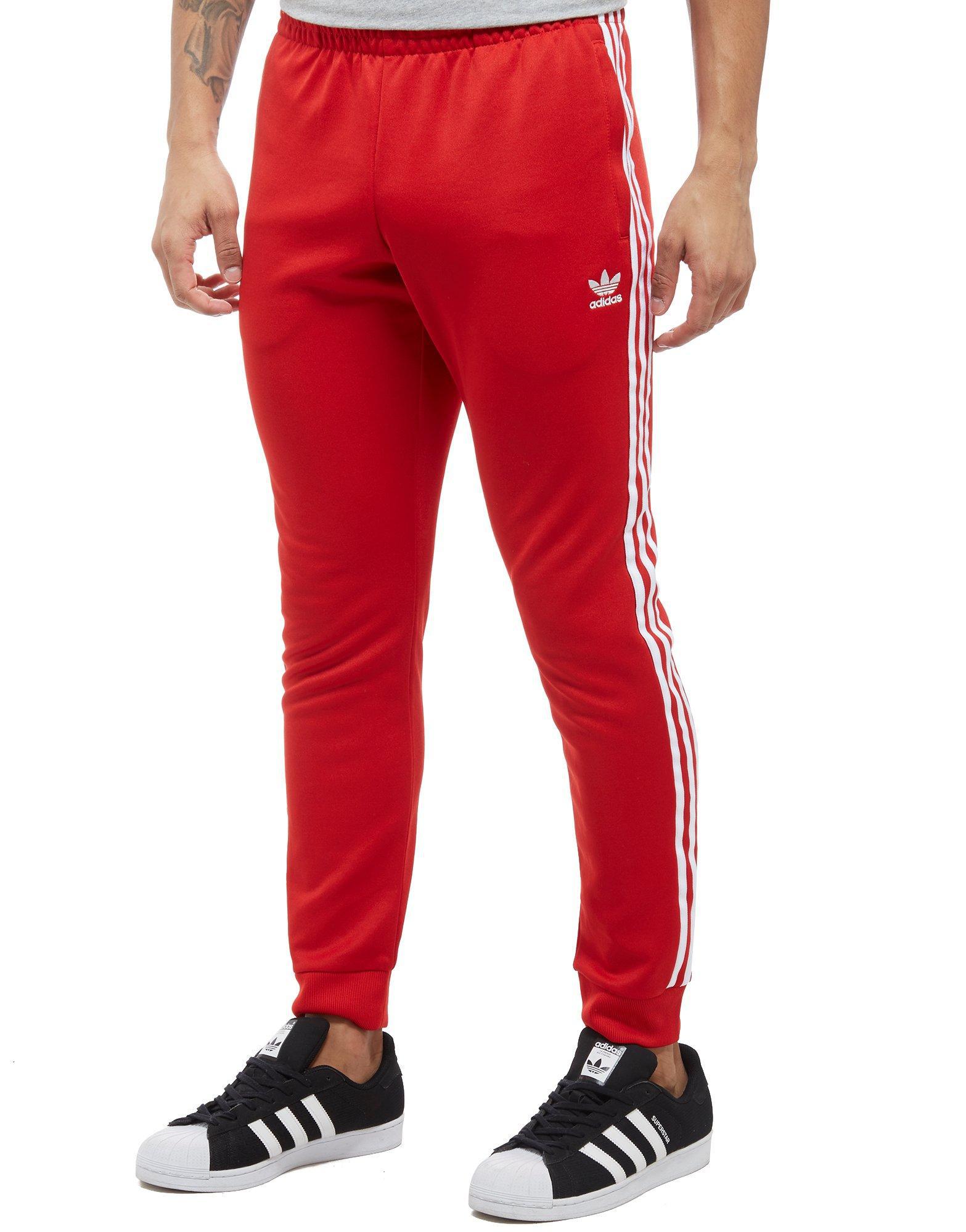 red adidas track pants