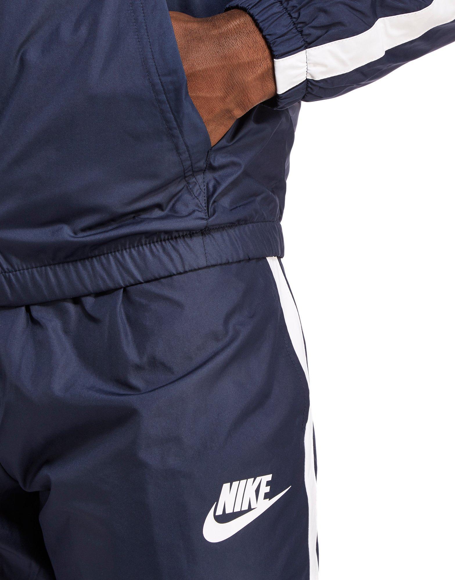 navy blue and white nike tracksuit