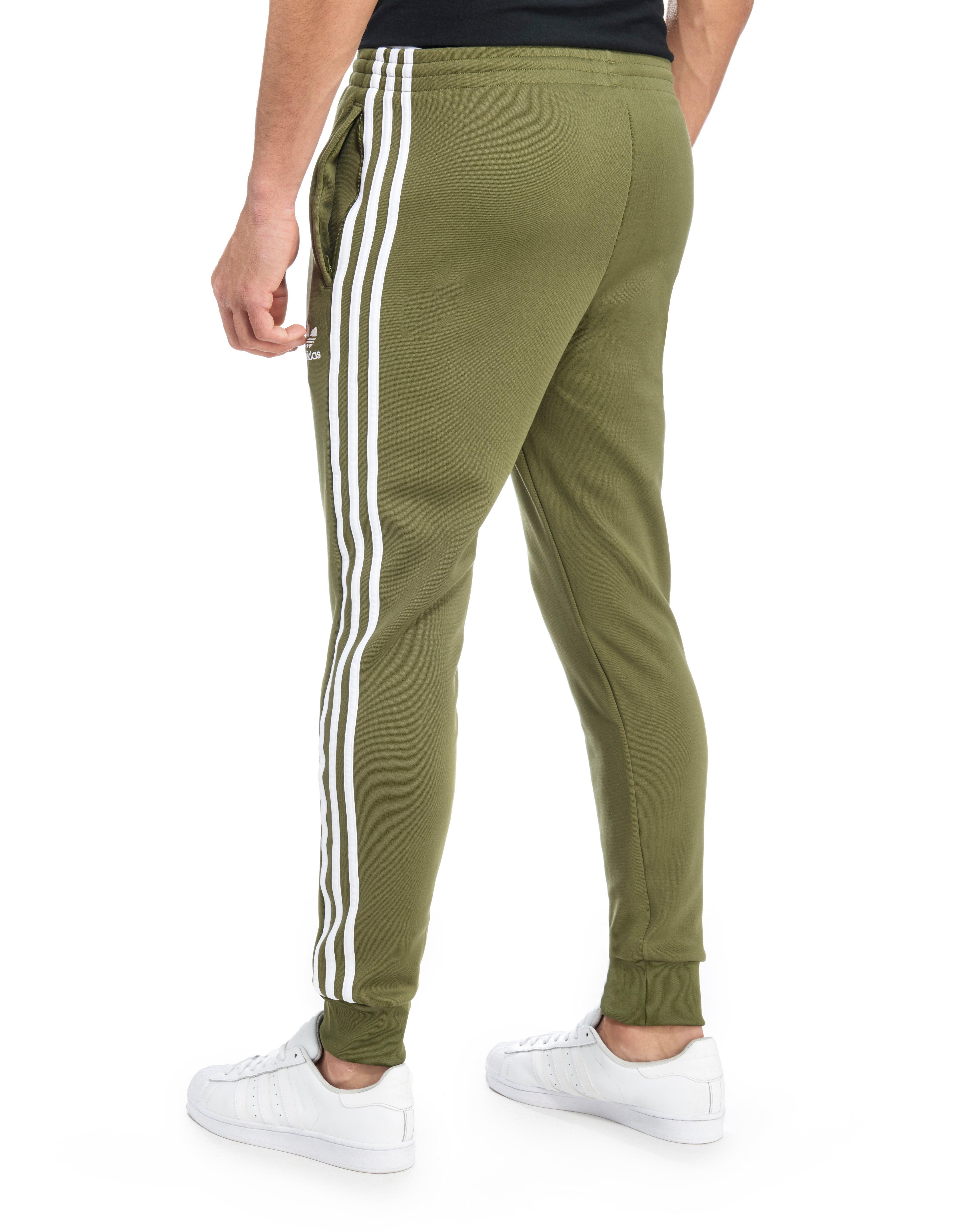 olive green adidas track pants sale 