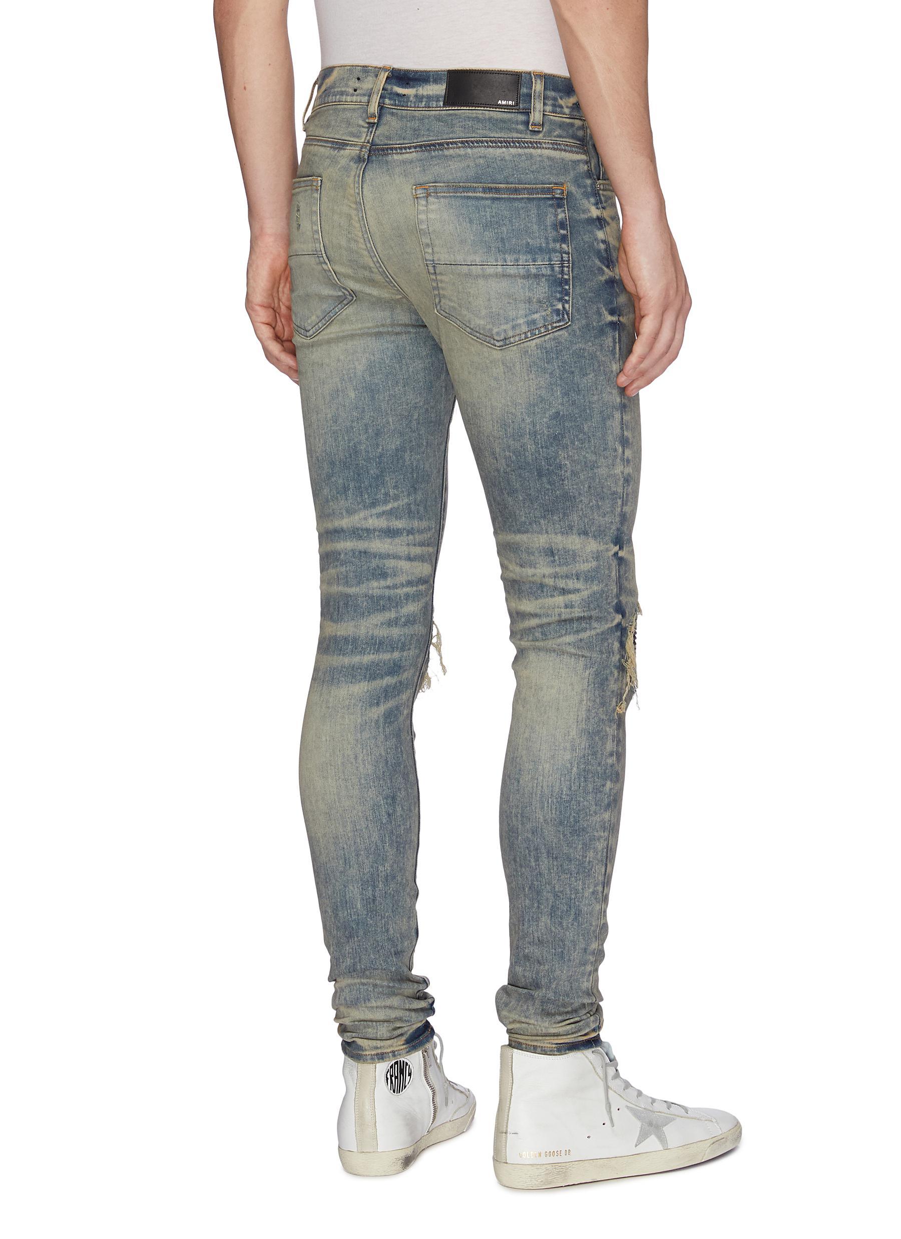 ripped jeans with bandana patches