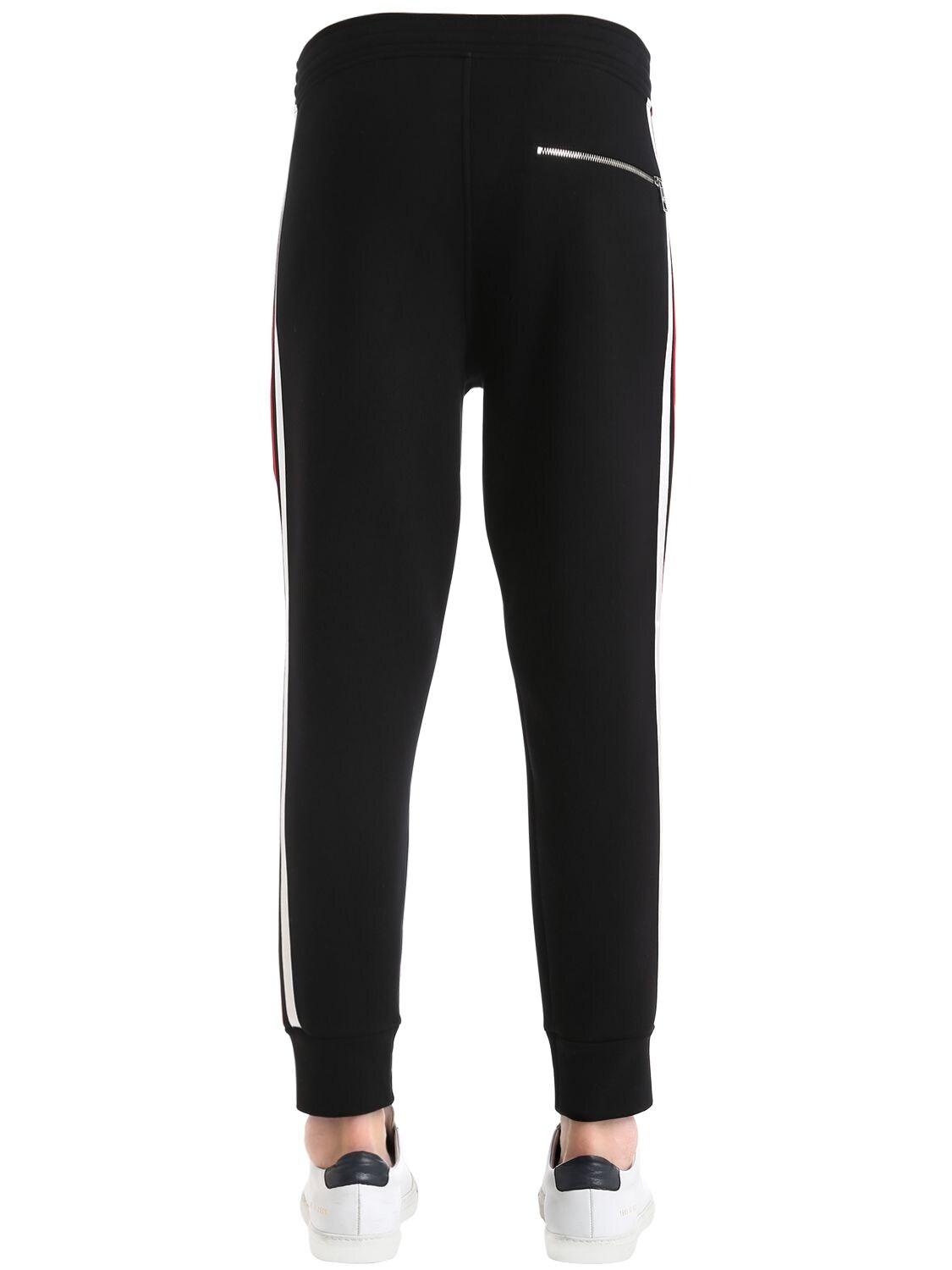 black sweatpants with red and white stripe