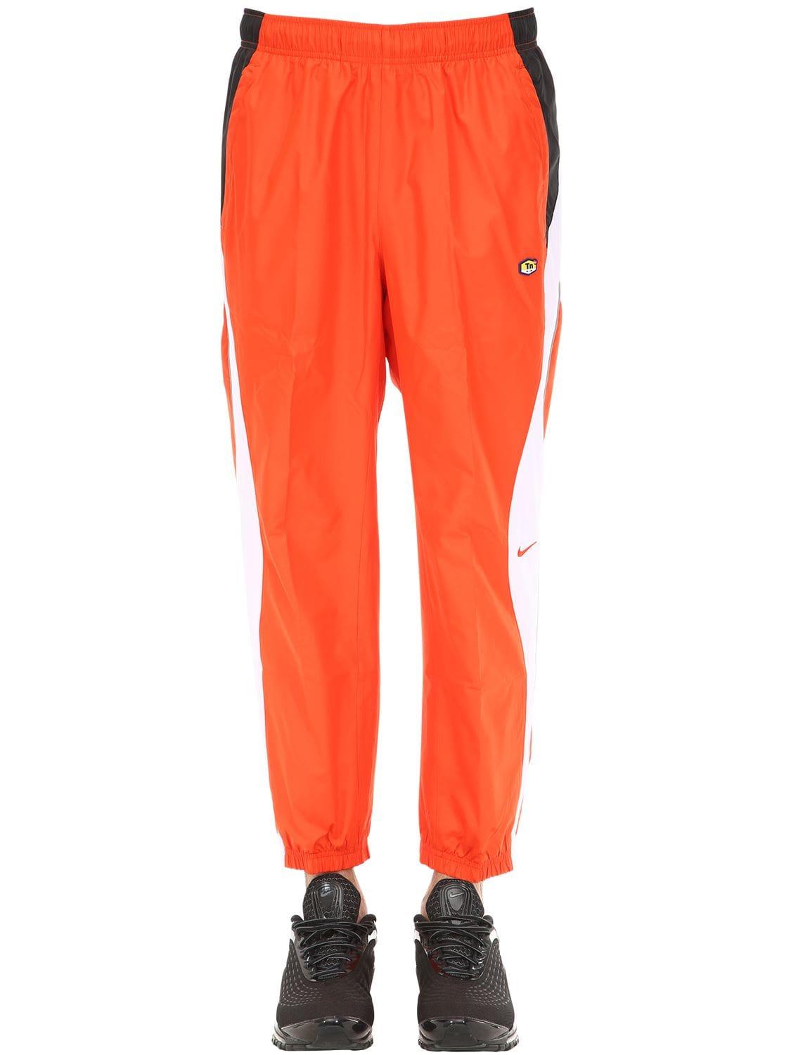 Nike Synthetic M Nrg Tn Nylon Track Pants in Orange for Men - Lyst