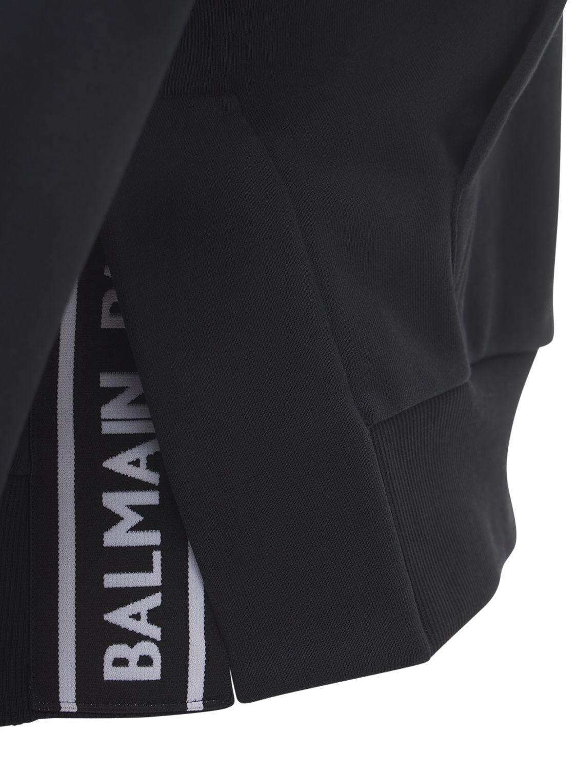 Balmain Cropped Cotton Hoodie W/ Flocked Logo in Black/White 