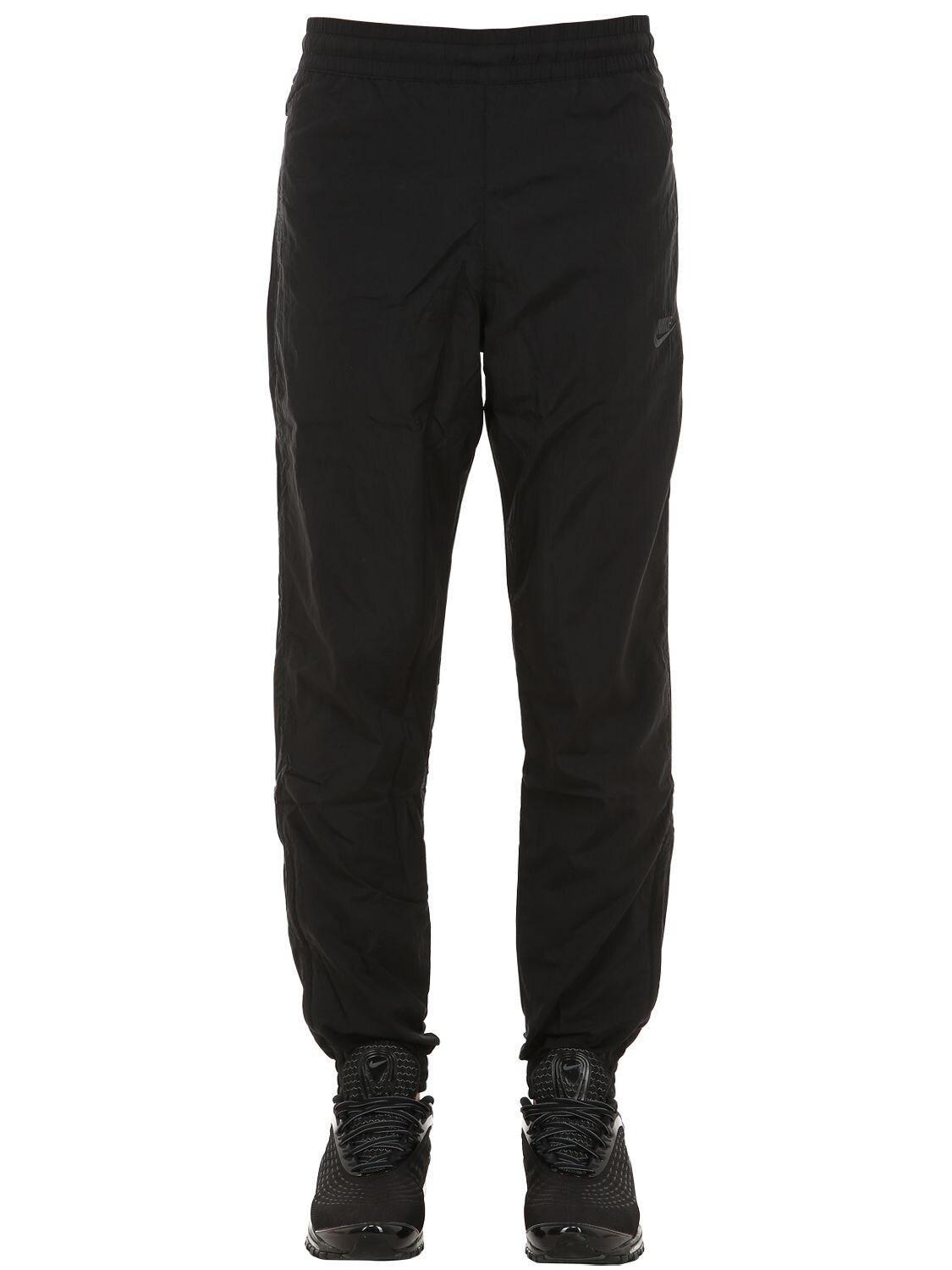 black nike swoosh woven track pants