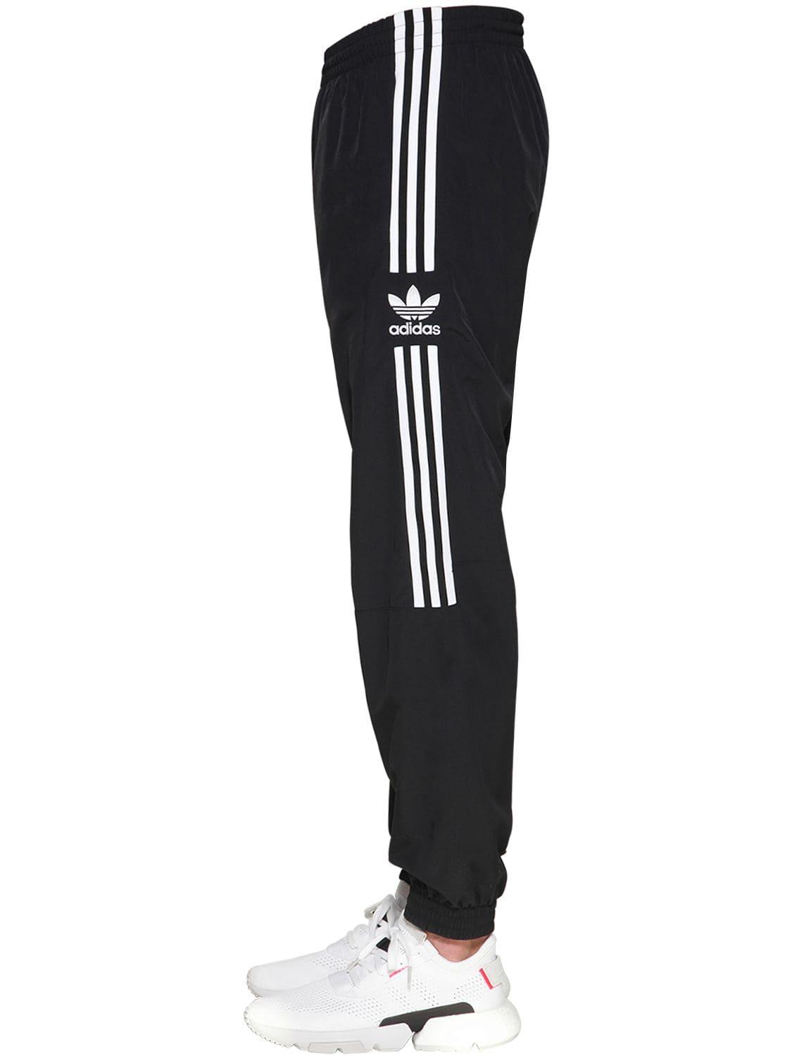 adidas originals adicolor locked up logo track pants in black