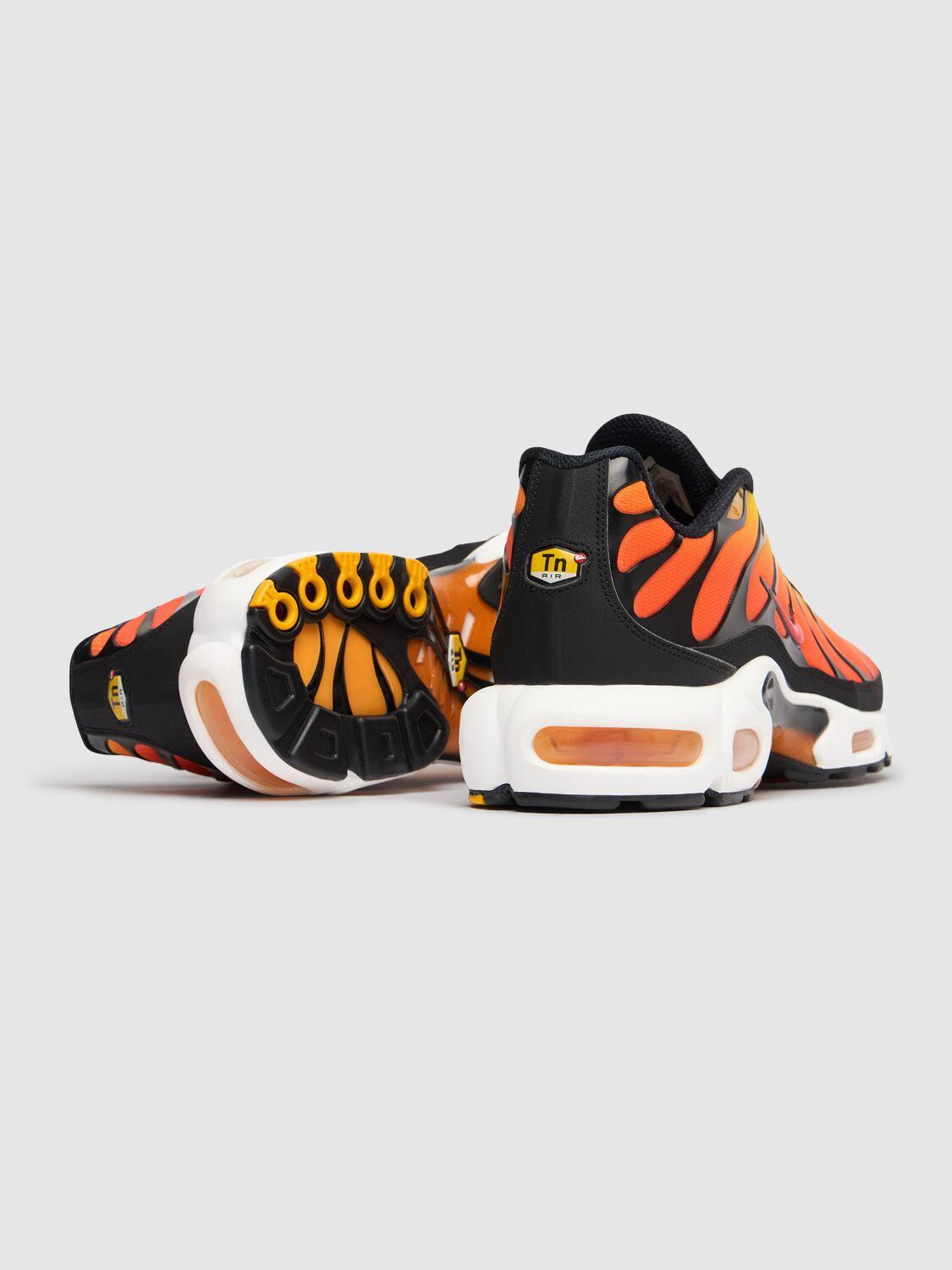 Black and orange nike air max plus sales