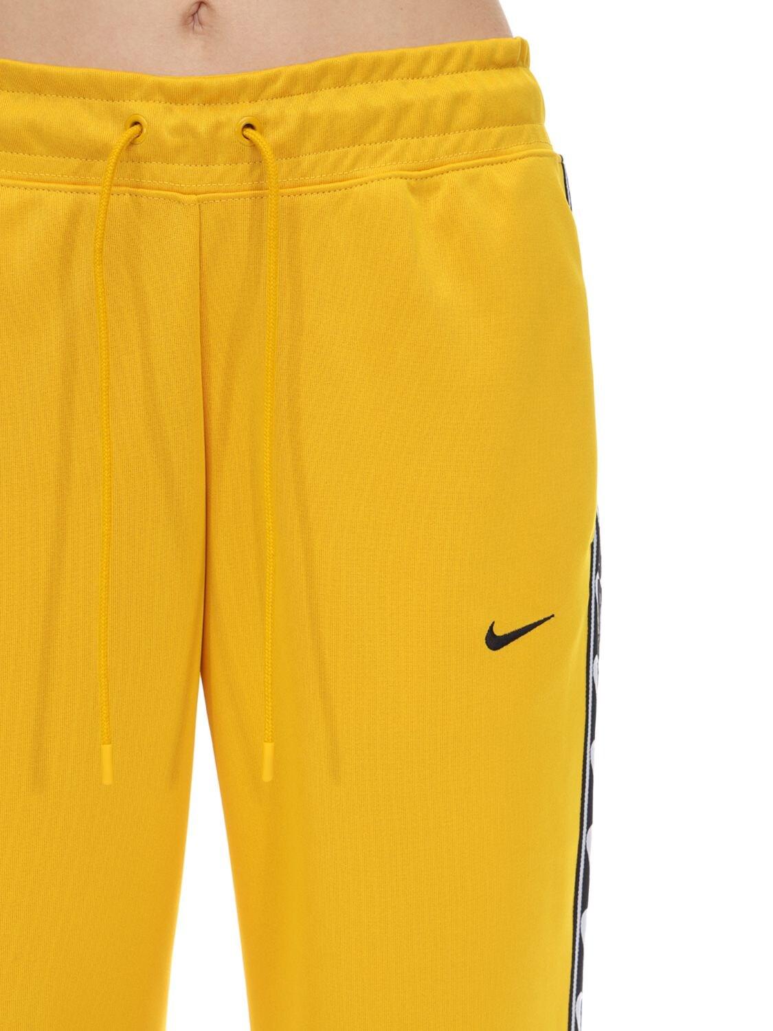 Nike Jogger Logo Tape Sweatpants in Yellow | Lyst