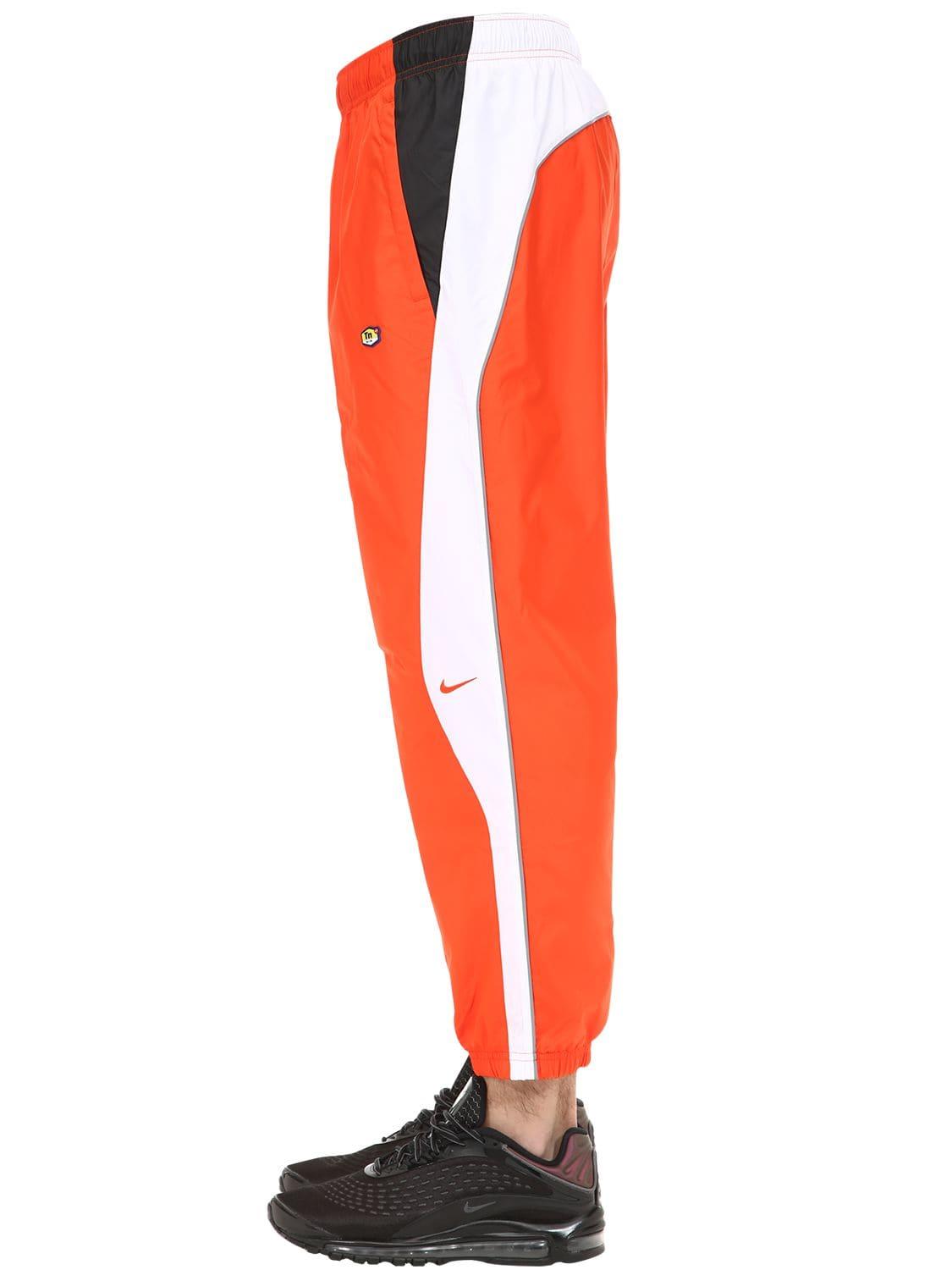 nike orange track pants
