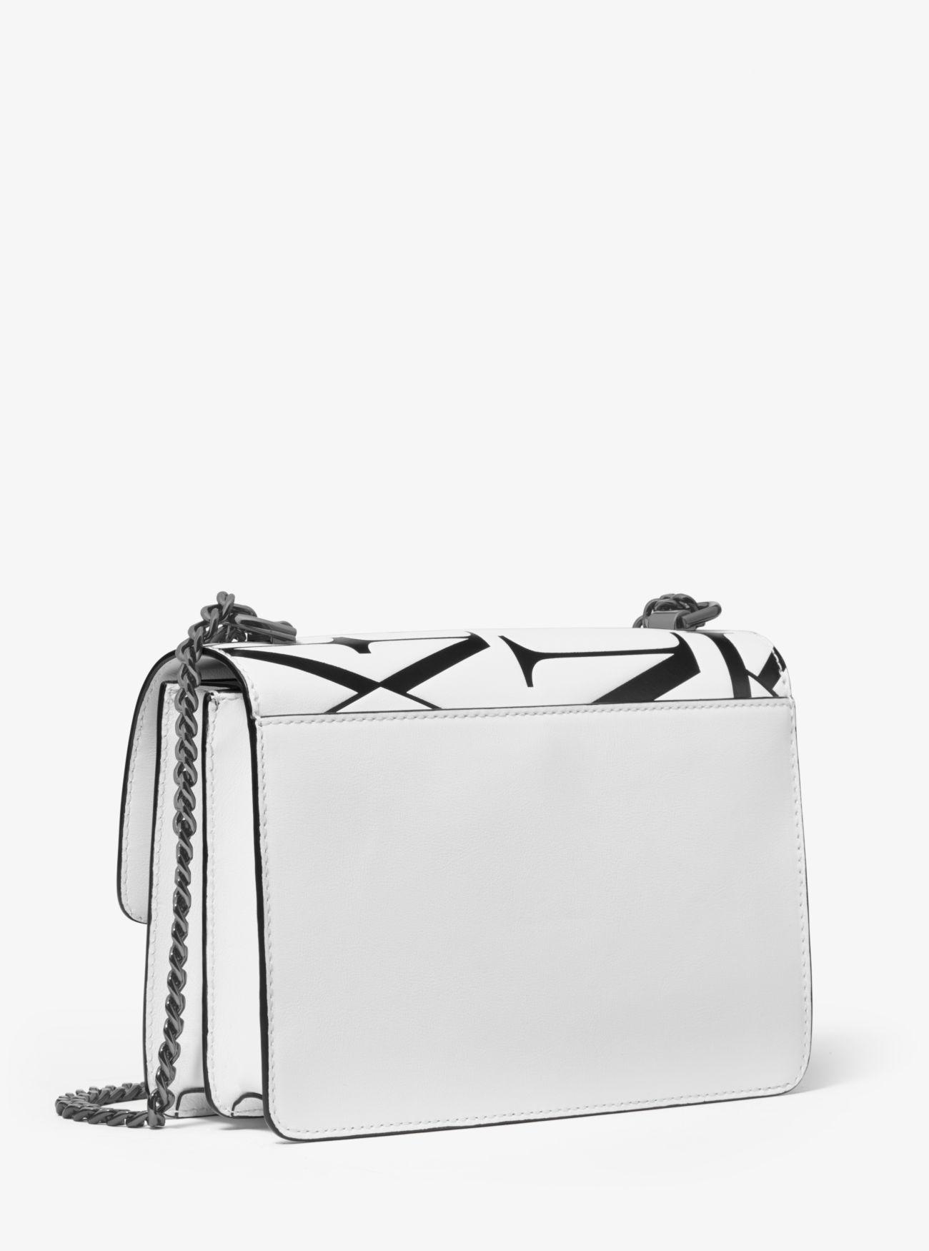 MICHAEL Michael Kors Jade Large Newsprint Logo Leather Crossbody Bag in Black (White) - Lyst