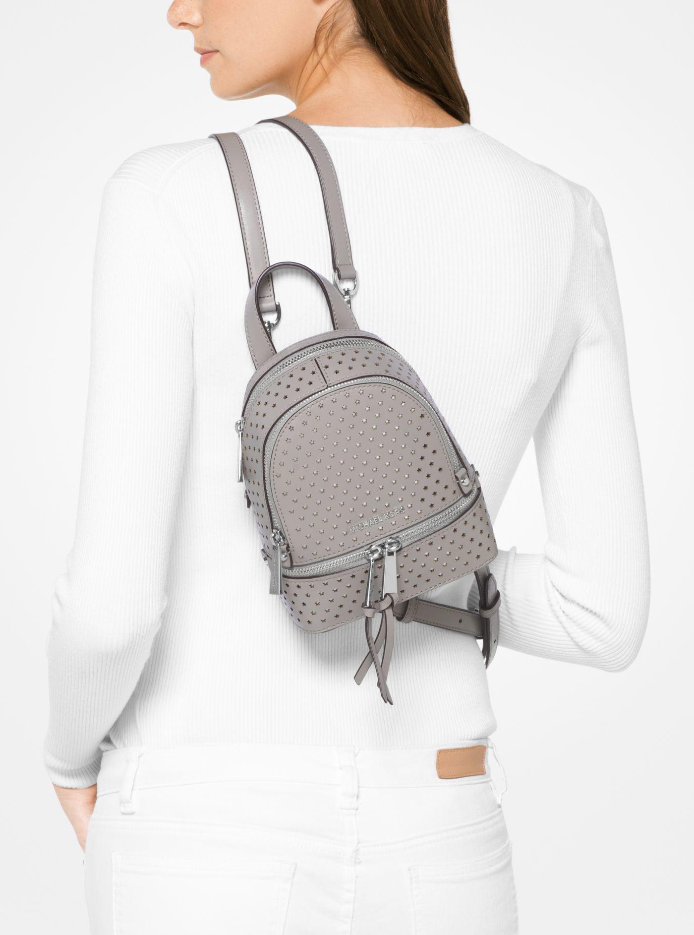 Michael Kors Leather Rhea Mini Perforated Backpack in Pearl Grey (Gray ...