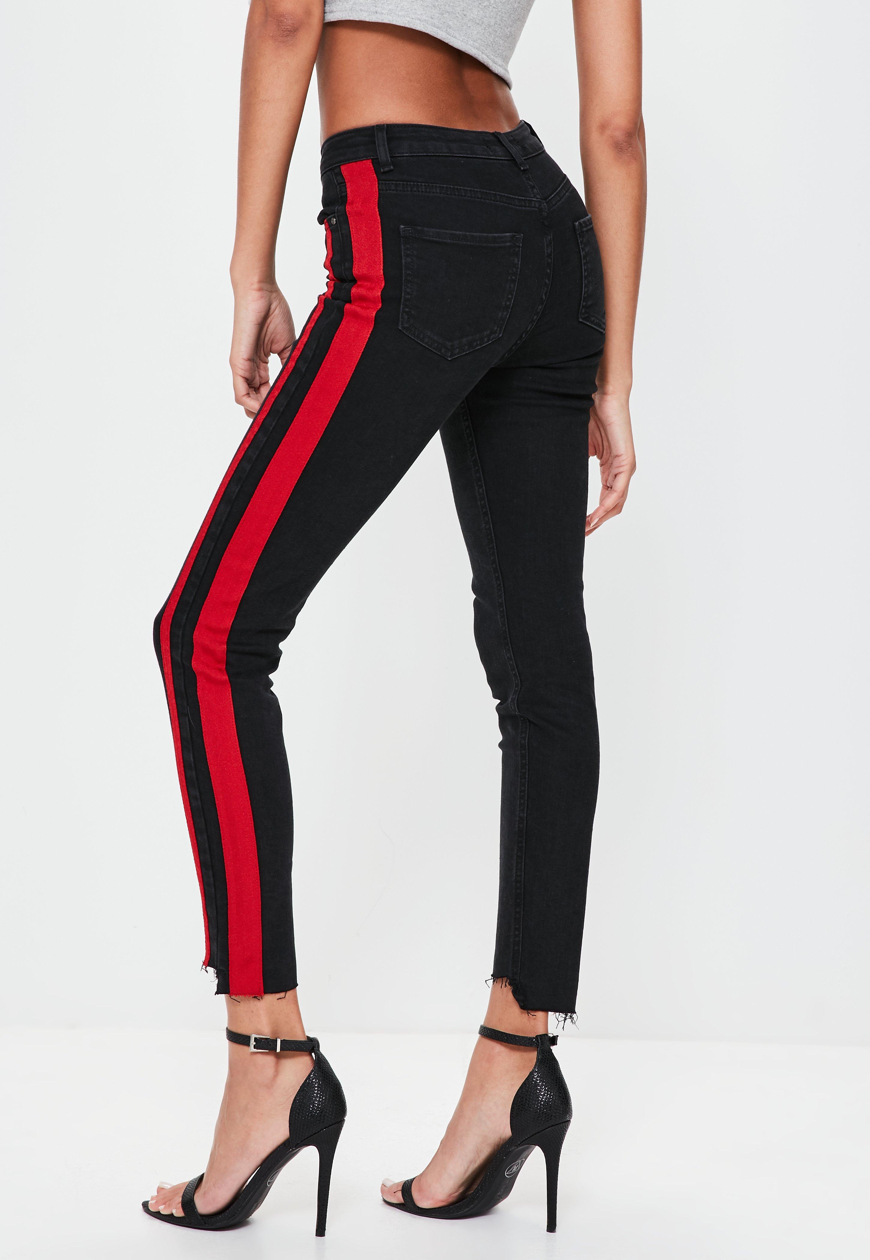 black jeans with red stripe down the side