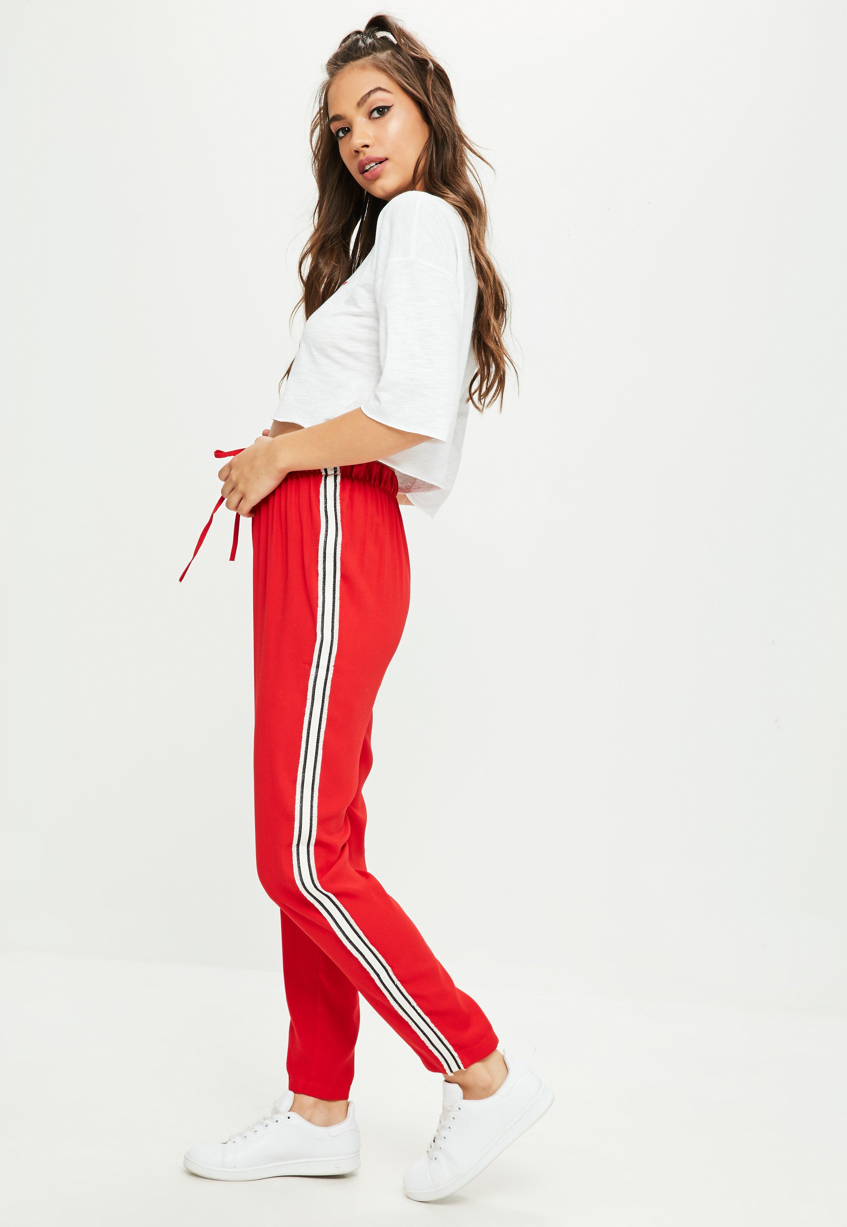 red track pants with white stripe