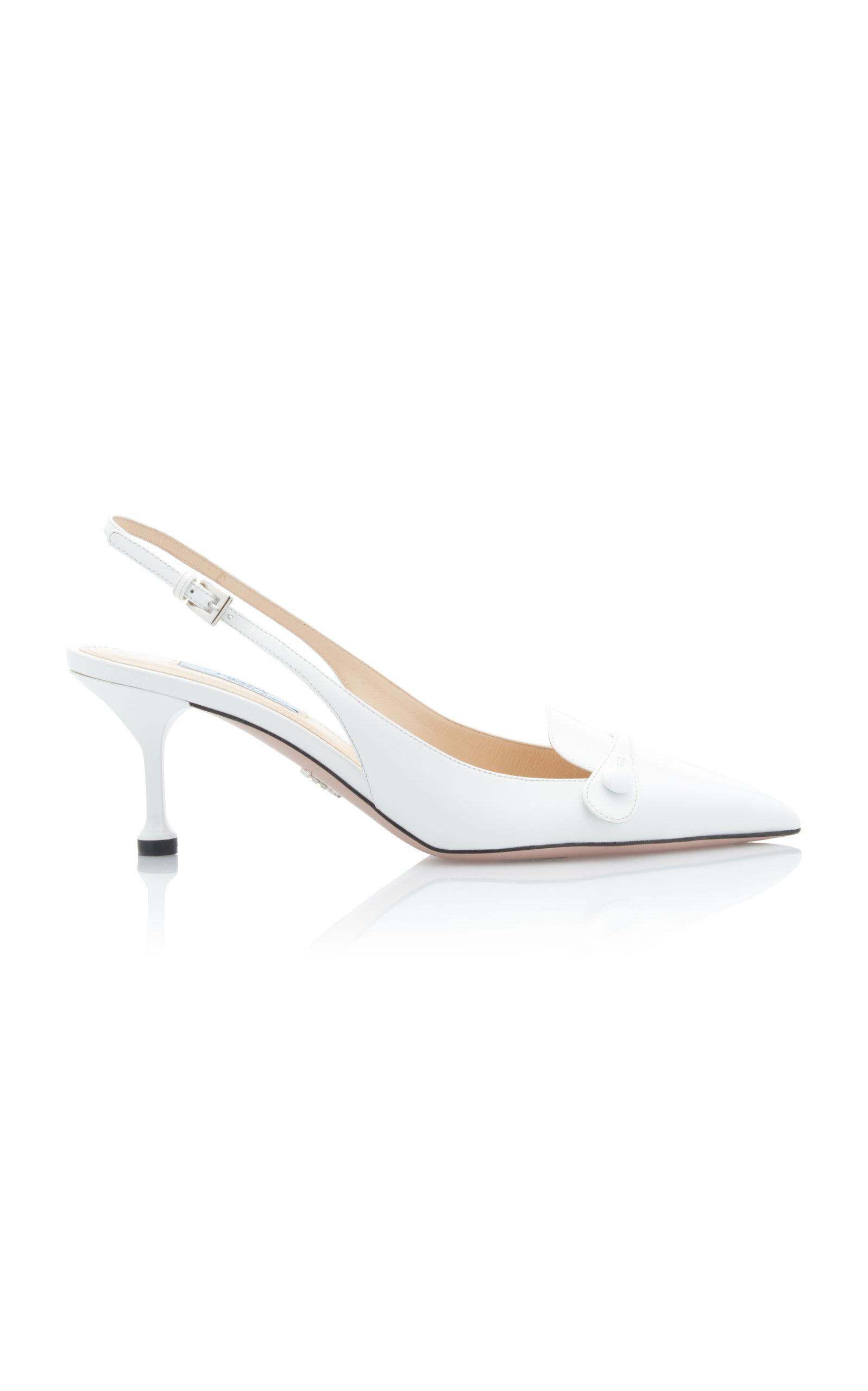WHITE OUT: Get a handle on @prada's sleek silhouettes. Adding an