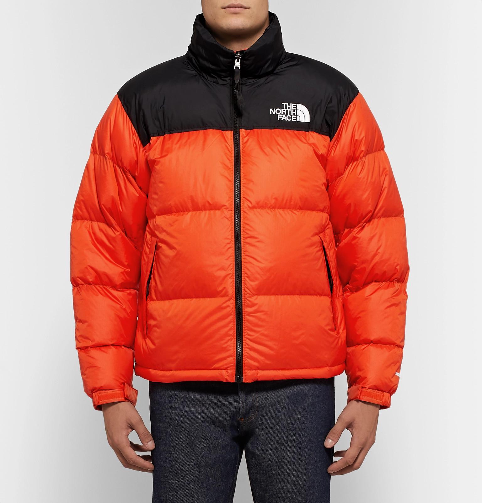 orange and black north face jacket