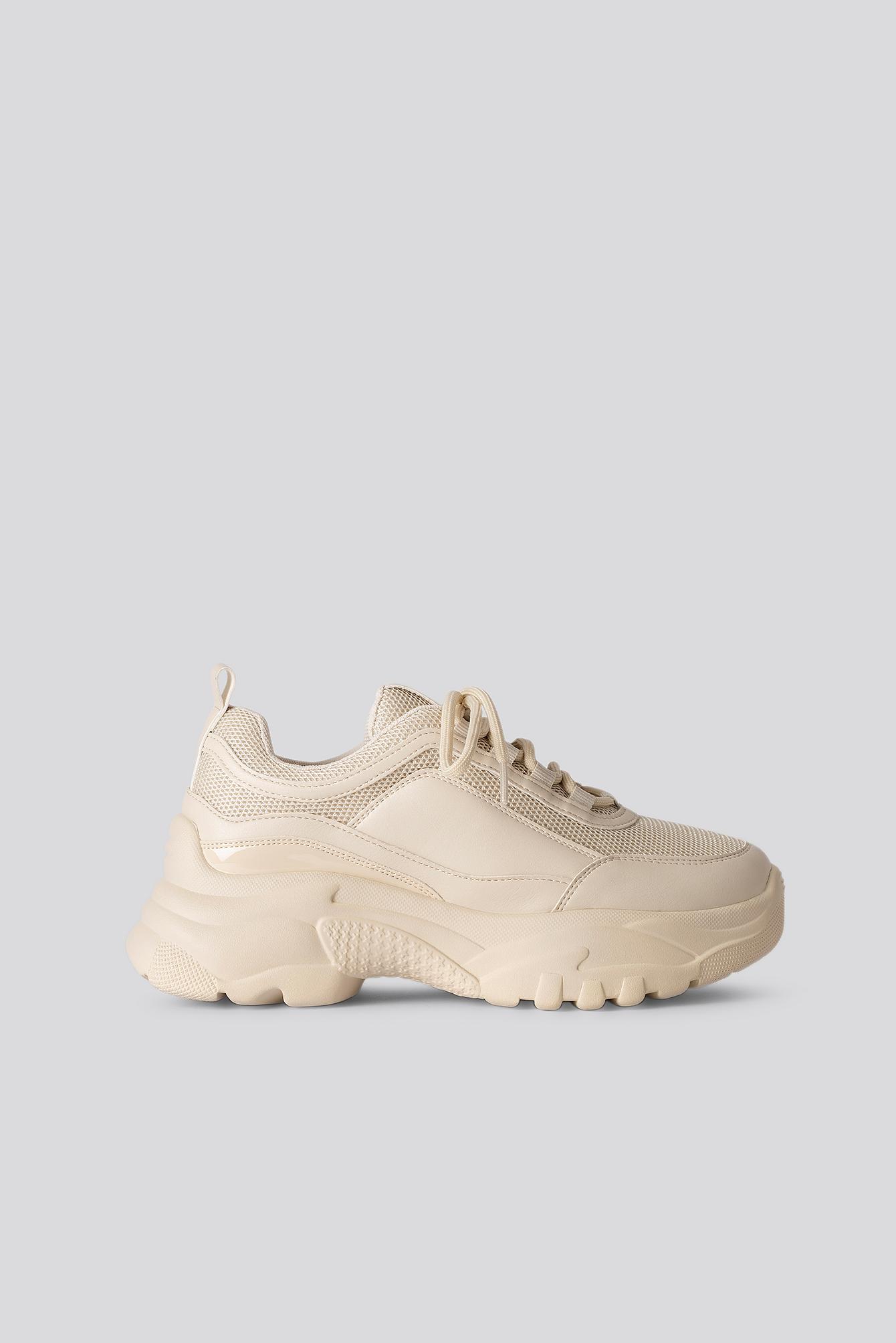 white and nude trainers