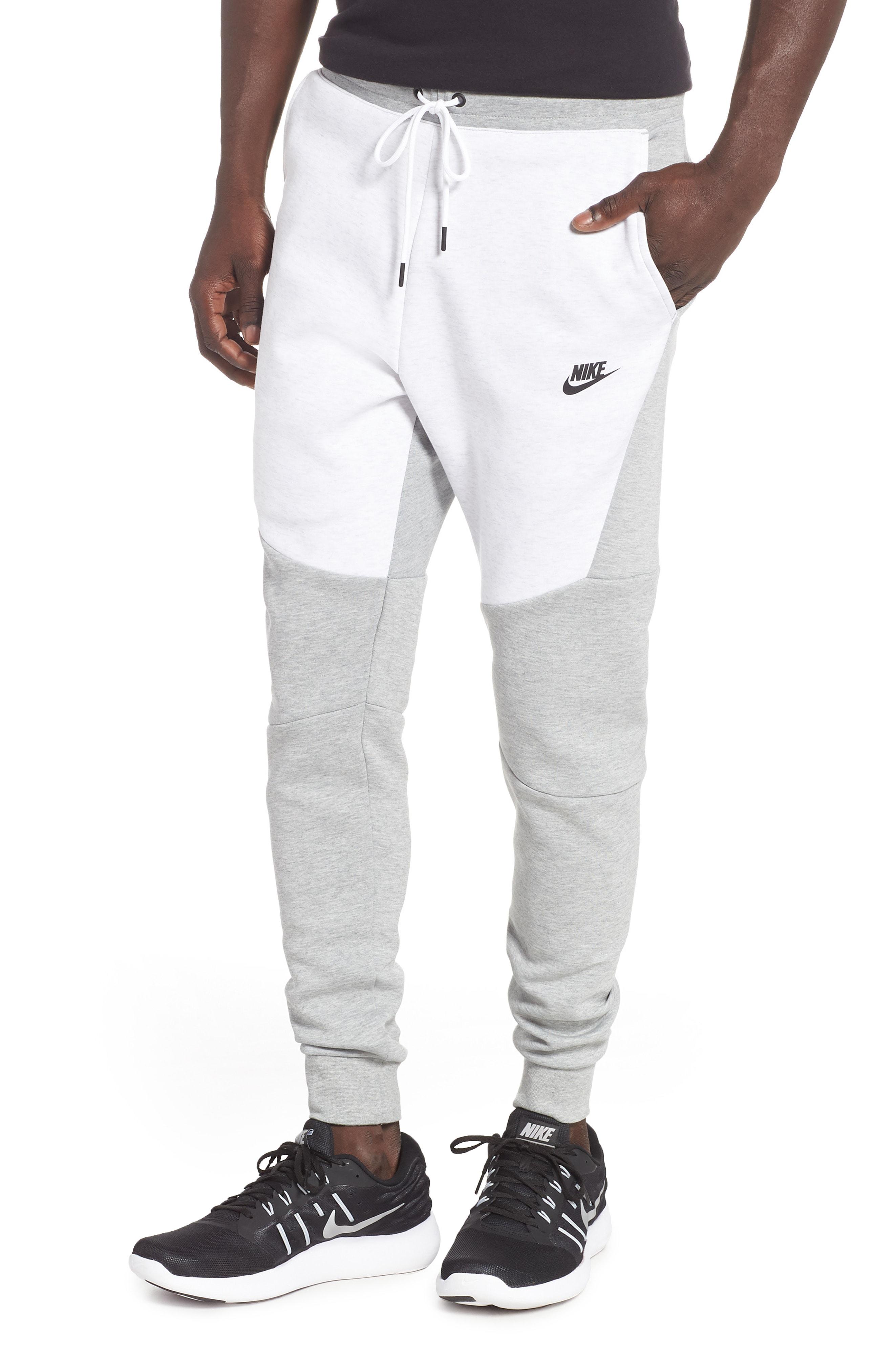 grey and white nike tech pants