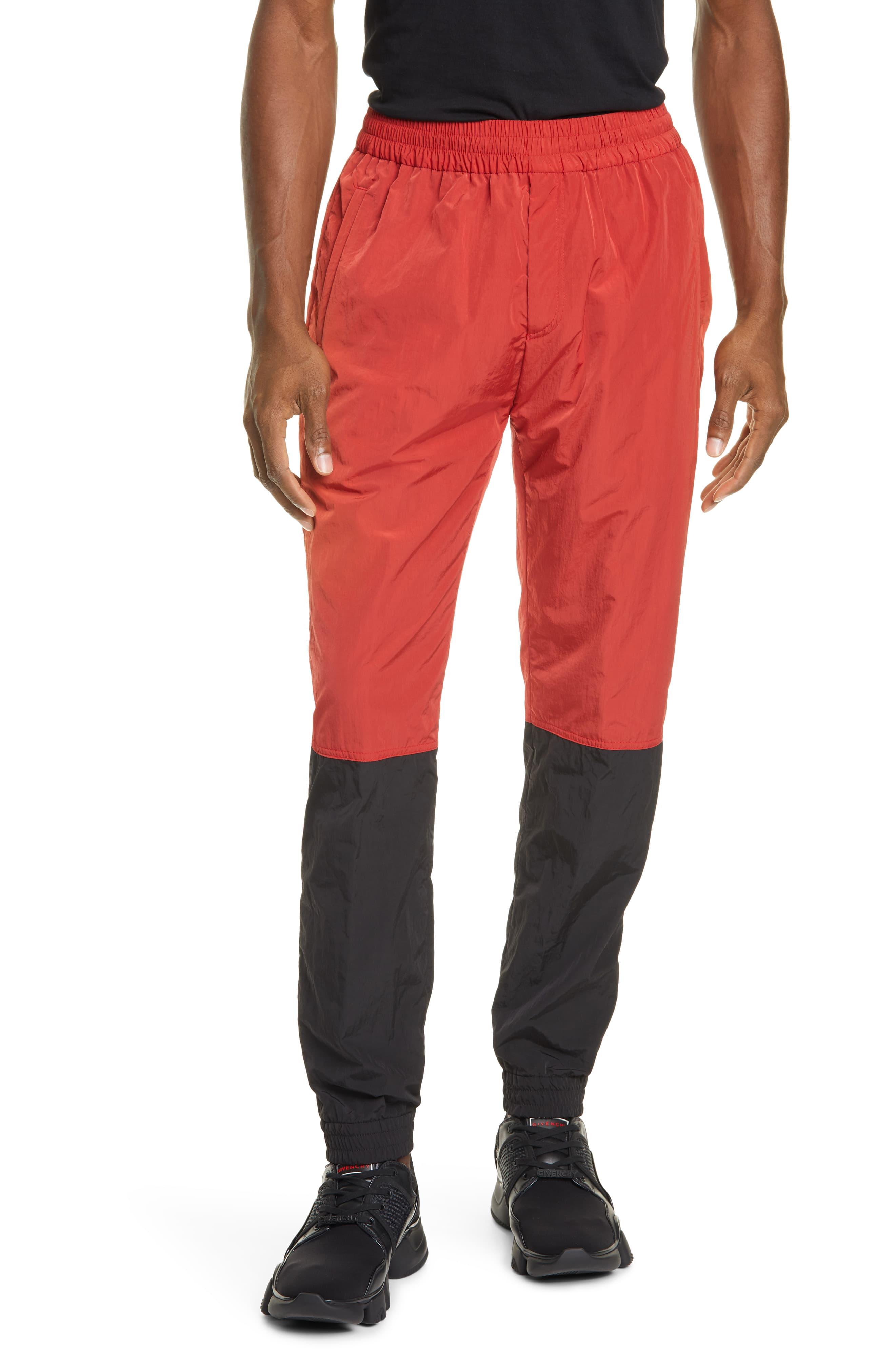 red nylon track pants